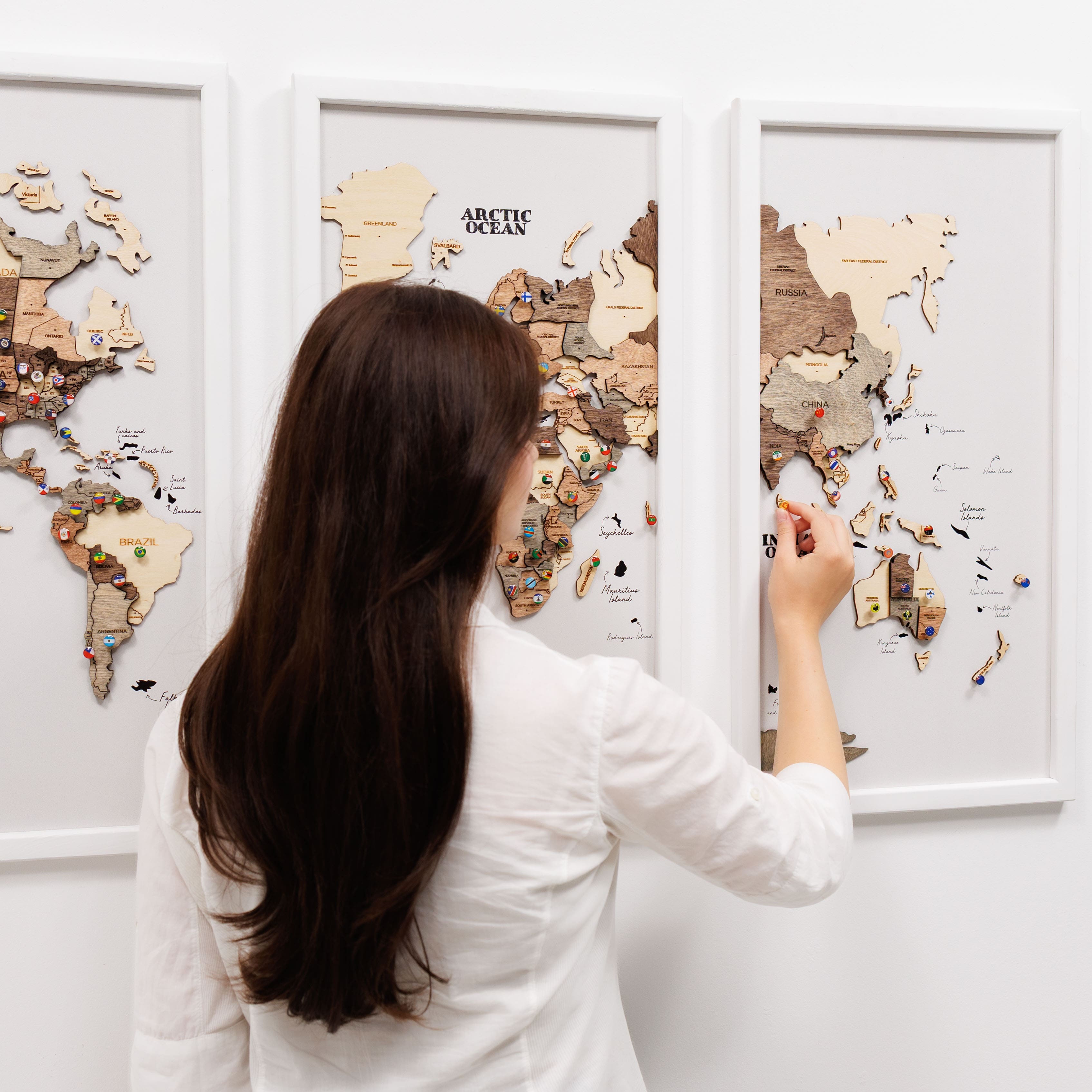 Wooden triptych wall art featuring a smokey finish and world map design by Enjoy The Wood, displayed in a three-panel wooden frame.
