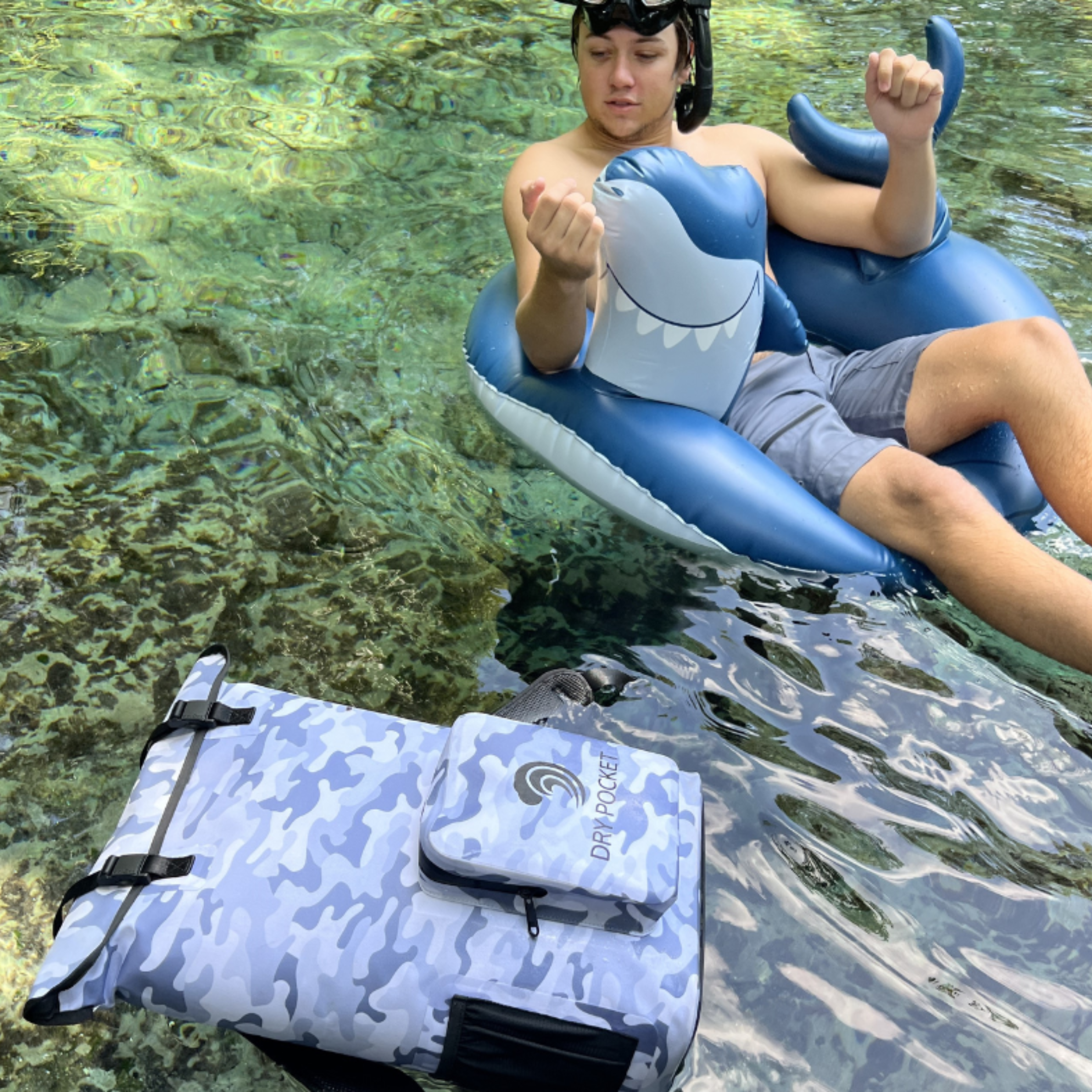 Dry Pocket waterproof floating backpack cooler in snow camo with adjustable straps and spacious insulated interior for keeping items cold.