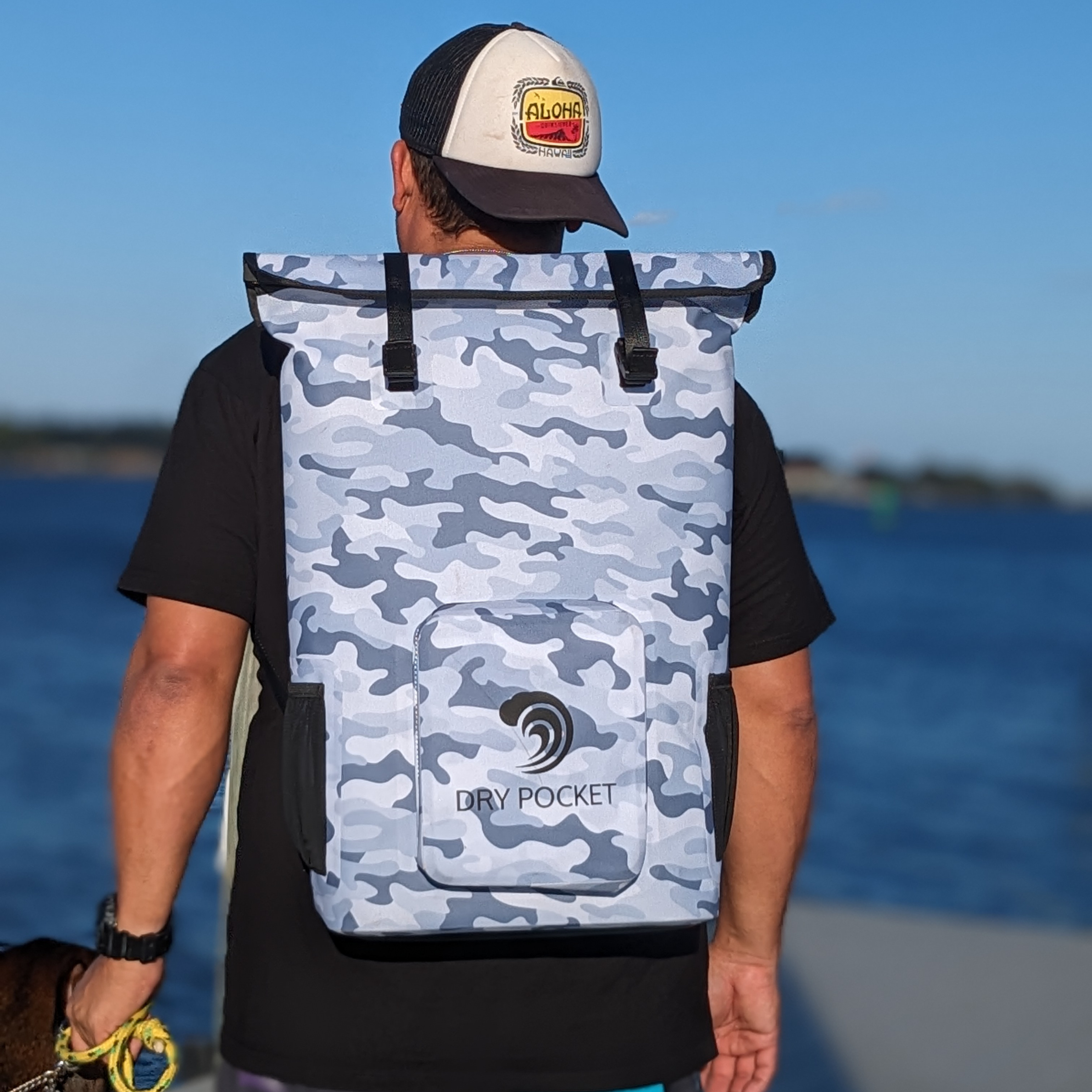 Snow camo waterproof floating backpack cooler by Dry Pocket with insulated interior and adjustable straps for outdoor adventures.