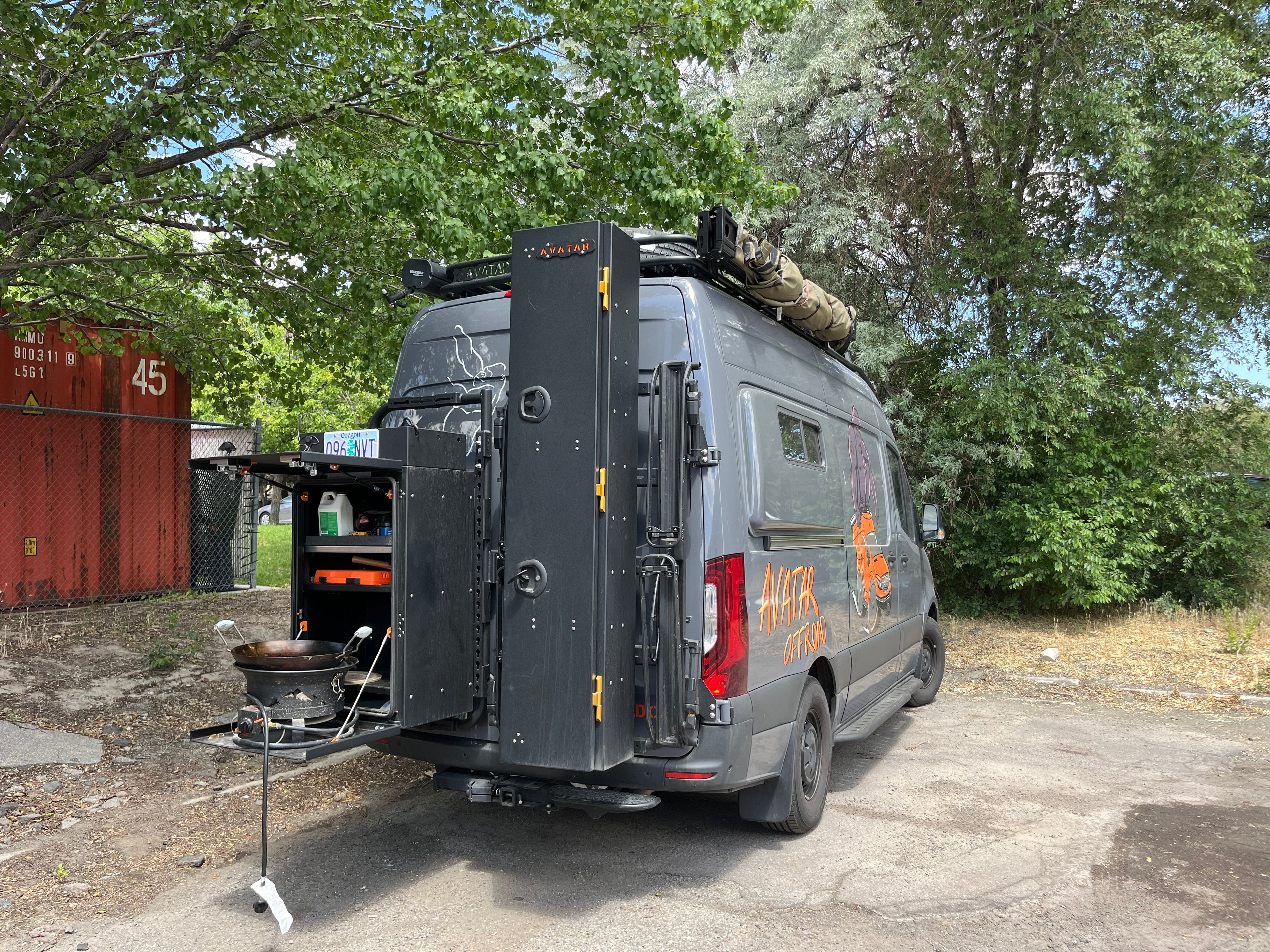 Avatar Offroad Massif Van Rear Door Storage Mounting System installed on a Sprinter van for organized exterior storage.