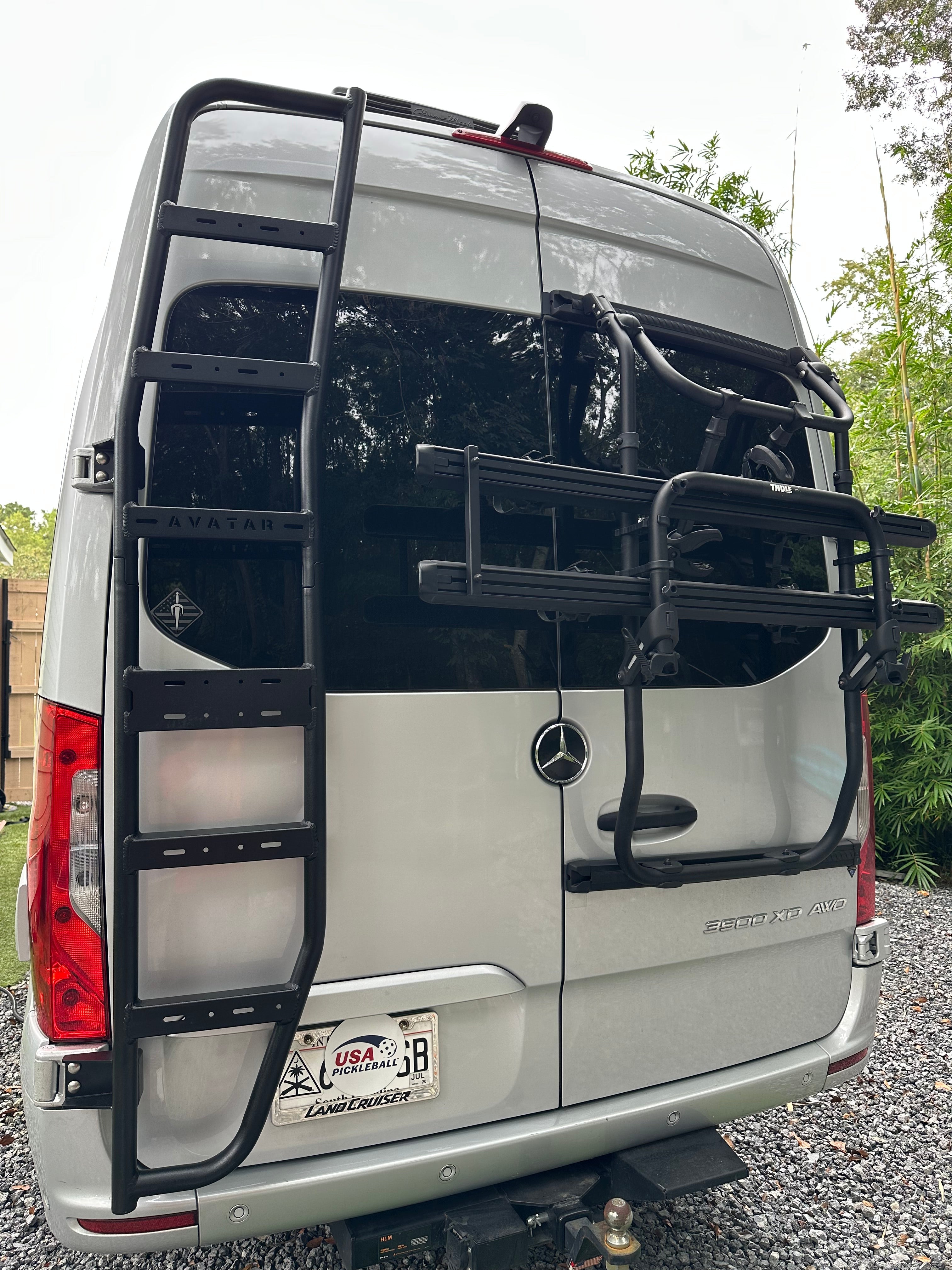 Avatar Offroad Sprinter Van Rear Ladder mounted on the back of a van for easy roof access and enhanced vehicle utility.