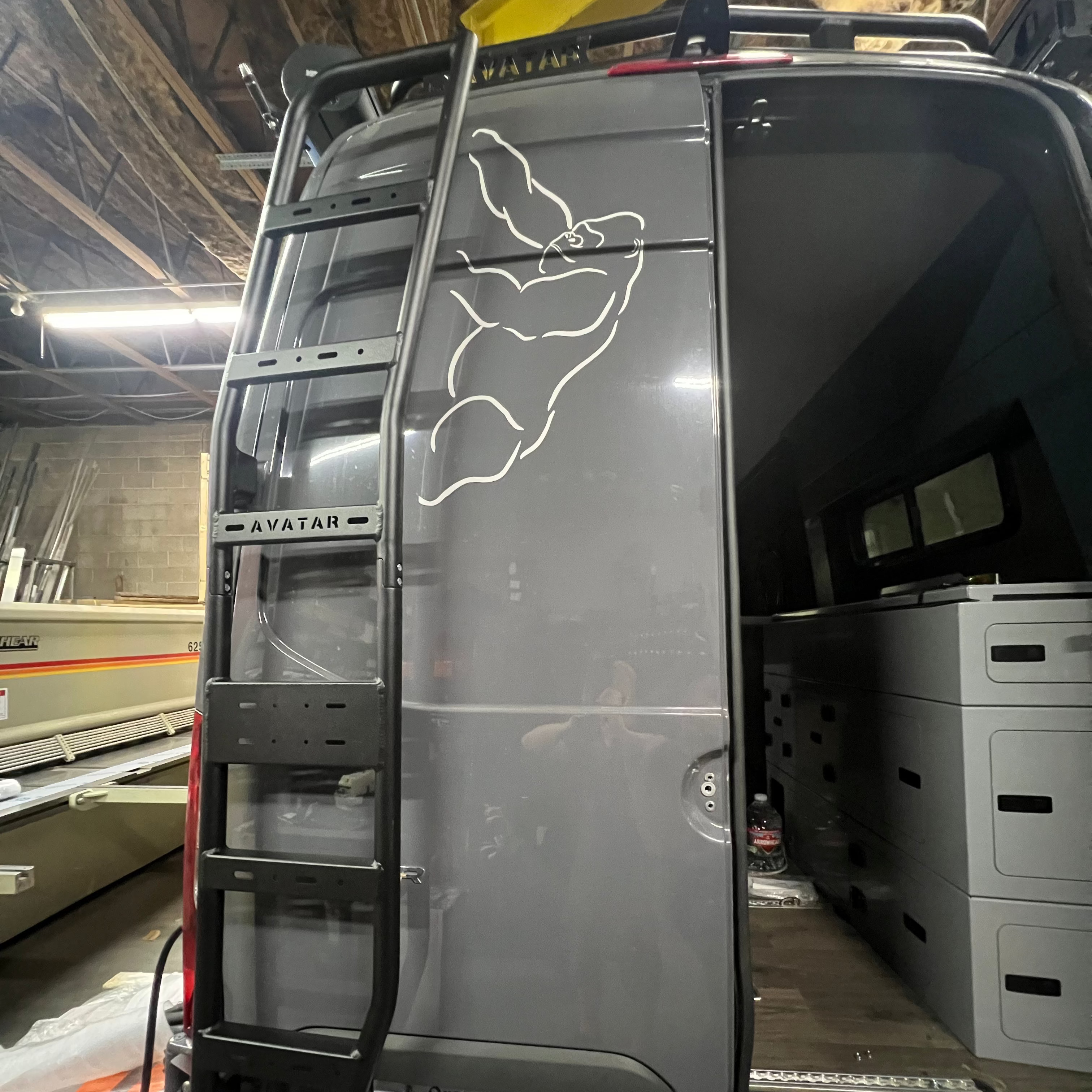 Avatar Offroad Sprinter Van Rear Ladder mounted on the back of a van for easy rooftop access. Durable aluminum construction.
