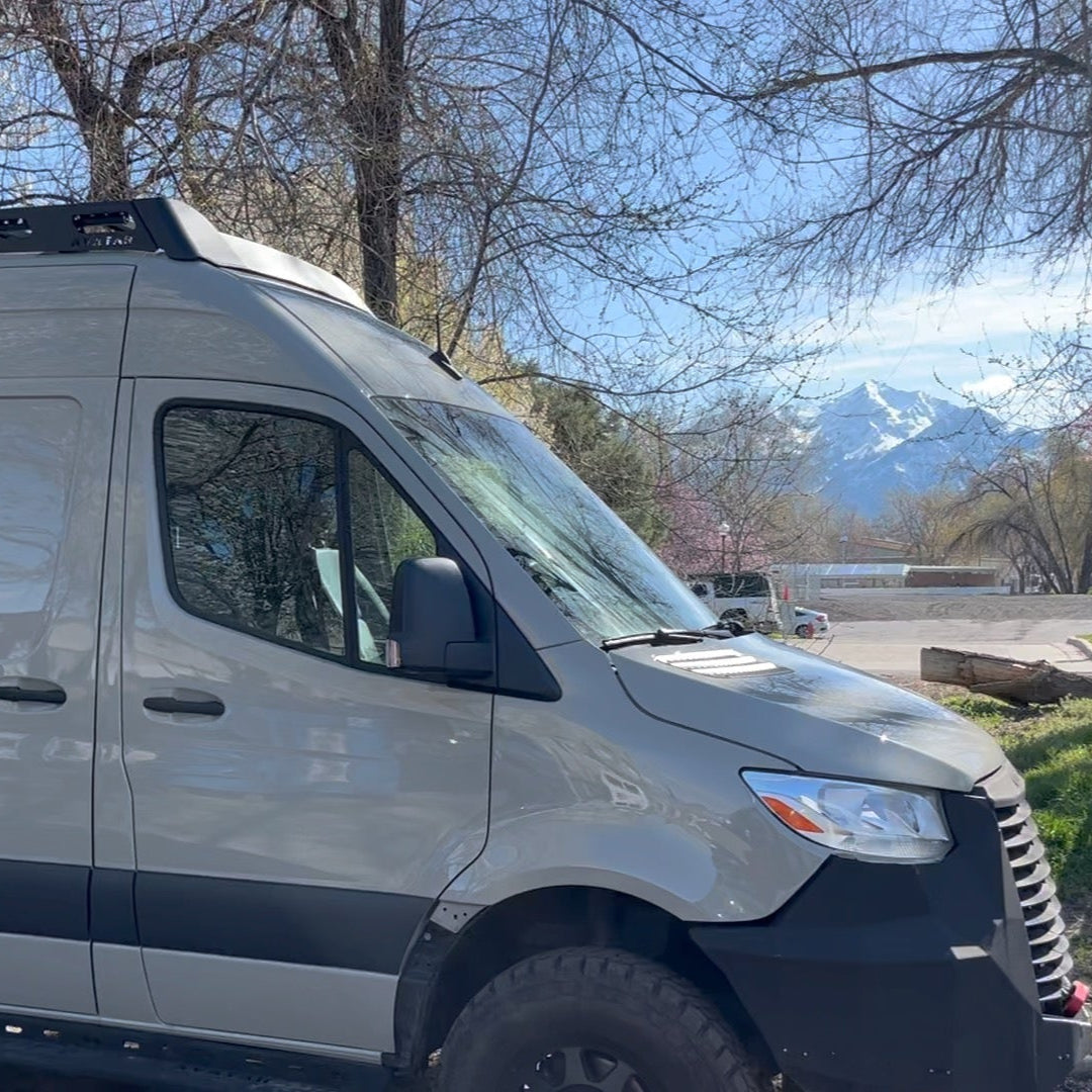 Avatar Offroad Pioneer Sprinter Roof Rack mounted on a van, with bumper visible, designed for durability and cargo capacity.