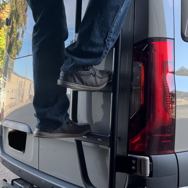 Avatar Offroad Sprinter Van Rear Ladder mounted on the back of a van for easy roof access and secure climbing.