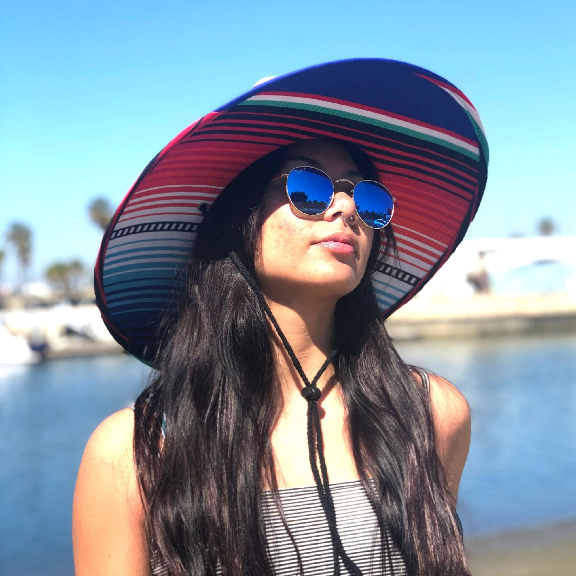 COR Surf straw lifeguard sun hat for adults, wide-brimmed beach hat made of woven straw with a stylish design and adjustable chin strap.