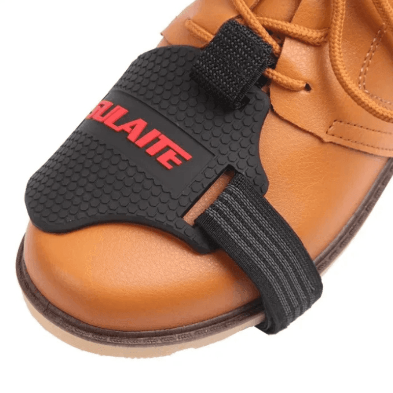 Bean's Moto Booth SULAITE™ motorcycle gear shift pad and shoe protector attached to black motorcycle boots for shift control.