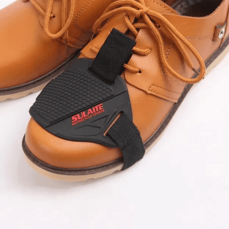 Bean's Moto Booth SULAITE™ motorcycle gear shift pad and shoe protector on black motorcycle boots, showing durable protective material.