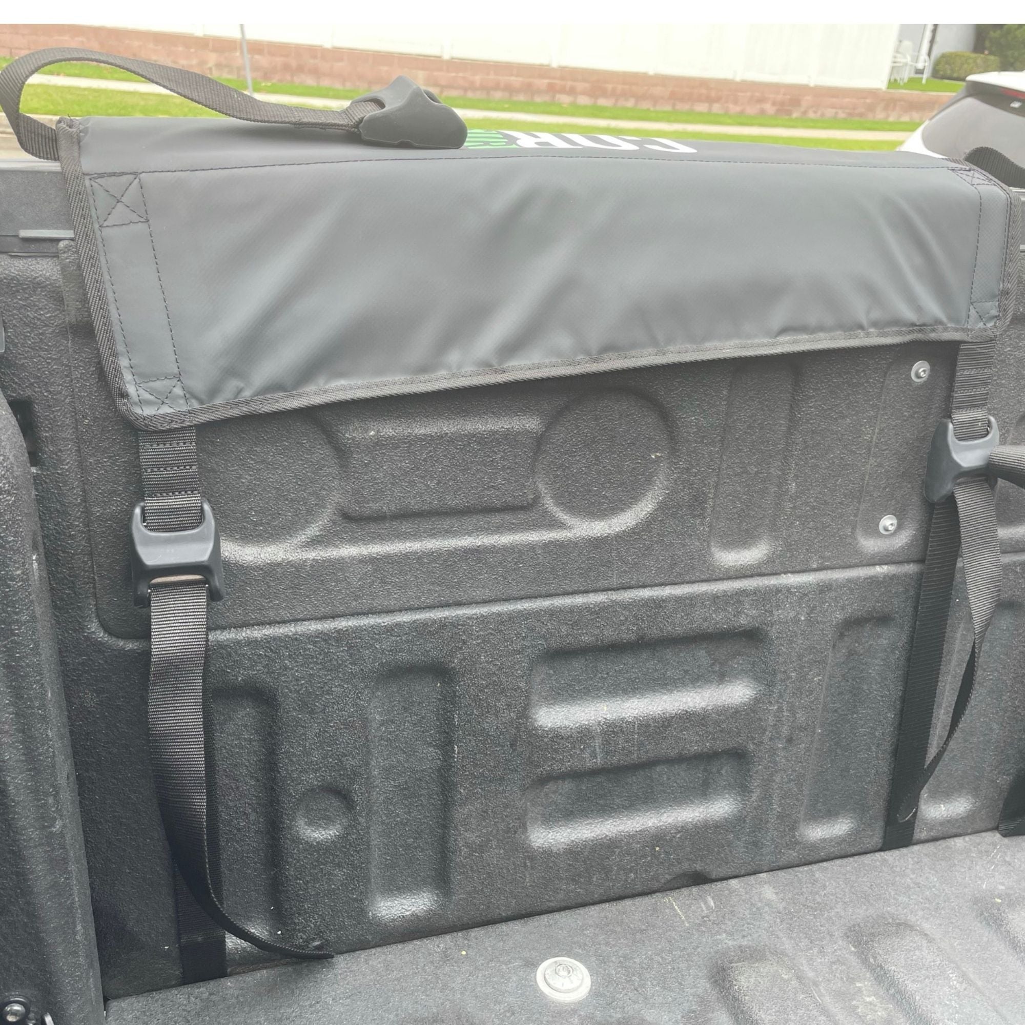 COR Surf tailgate truck pad for surfboards and paddleboards, sturdy surf rack attached to vehicle tailgate for outdoor adventures.