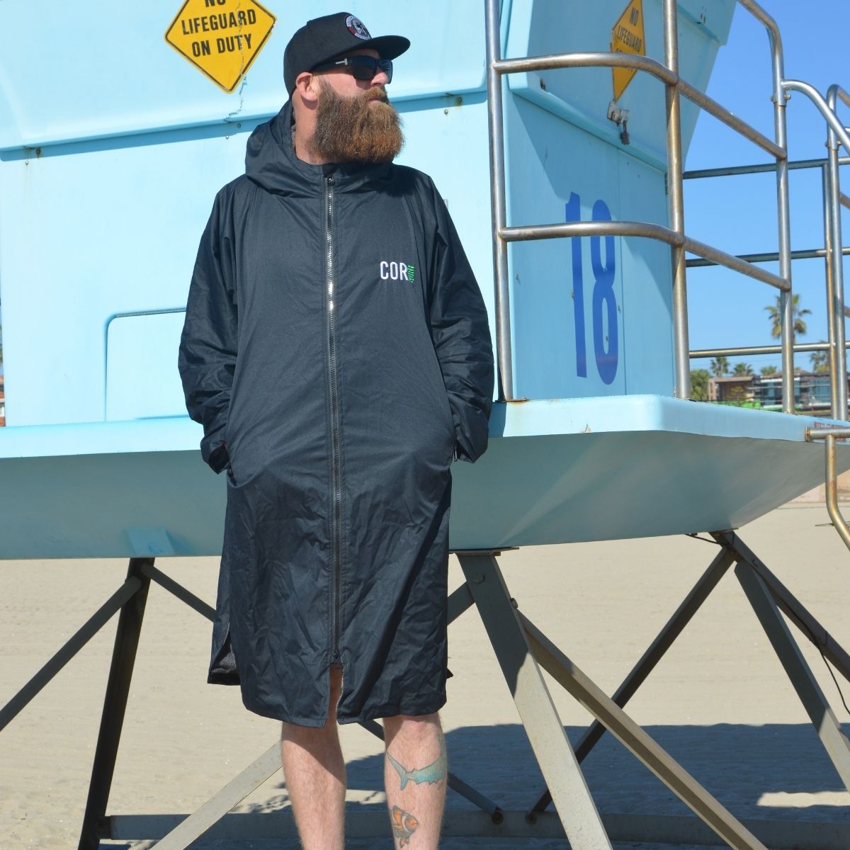 Black waterproof swim parka by COR Surf, men's XL size, showing a lightweight, water-resistant jacket suitable for outdoor water activities.