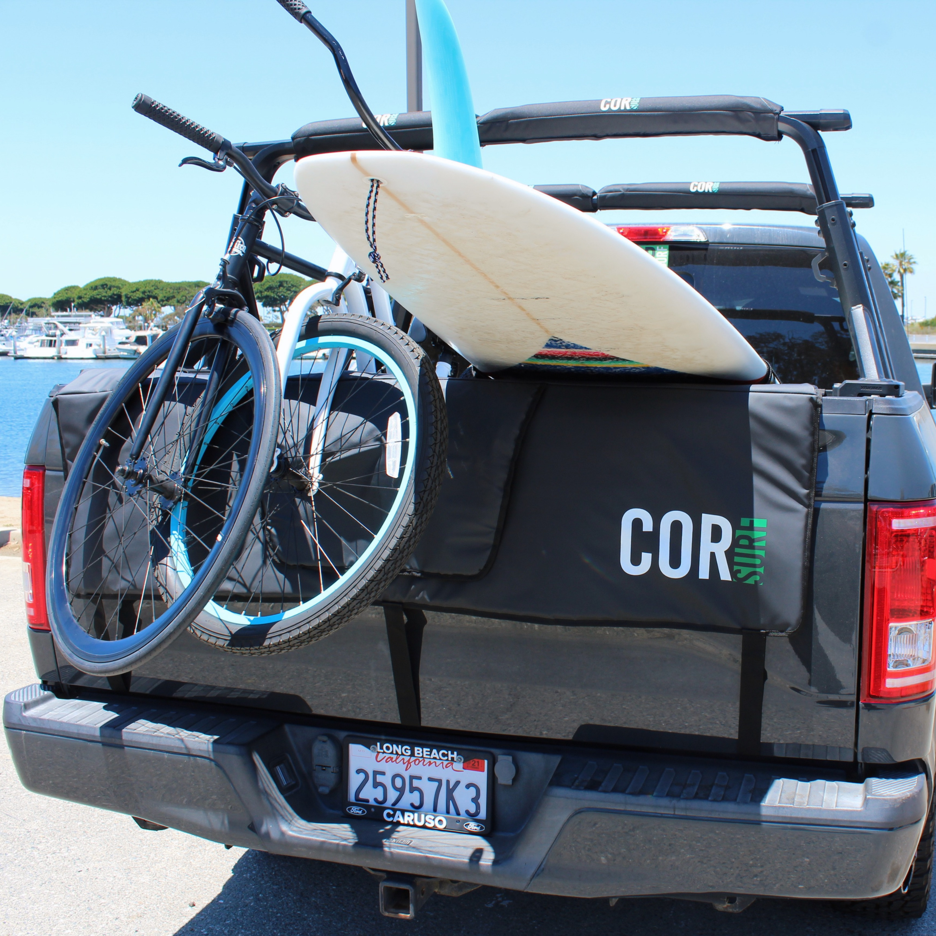 COR Surf tailgate pad for bikes and surfboards, shown in two sizes, with padded straps and durable fabric for vehicle protection.