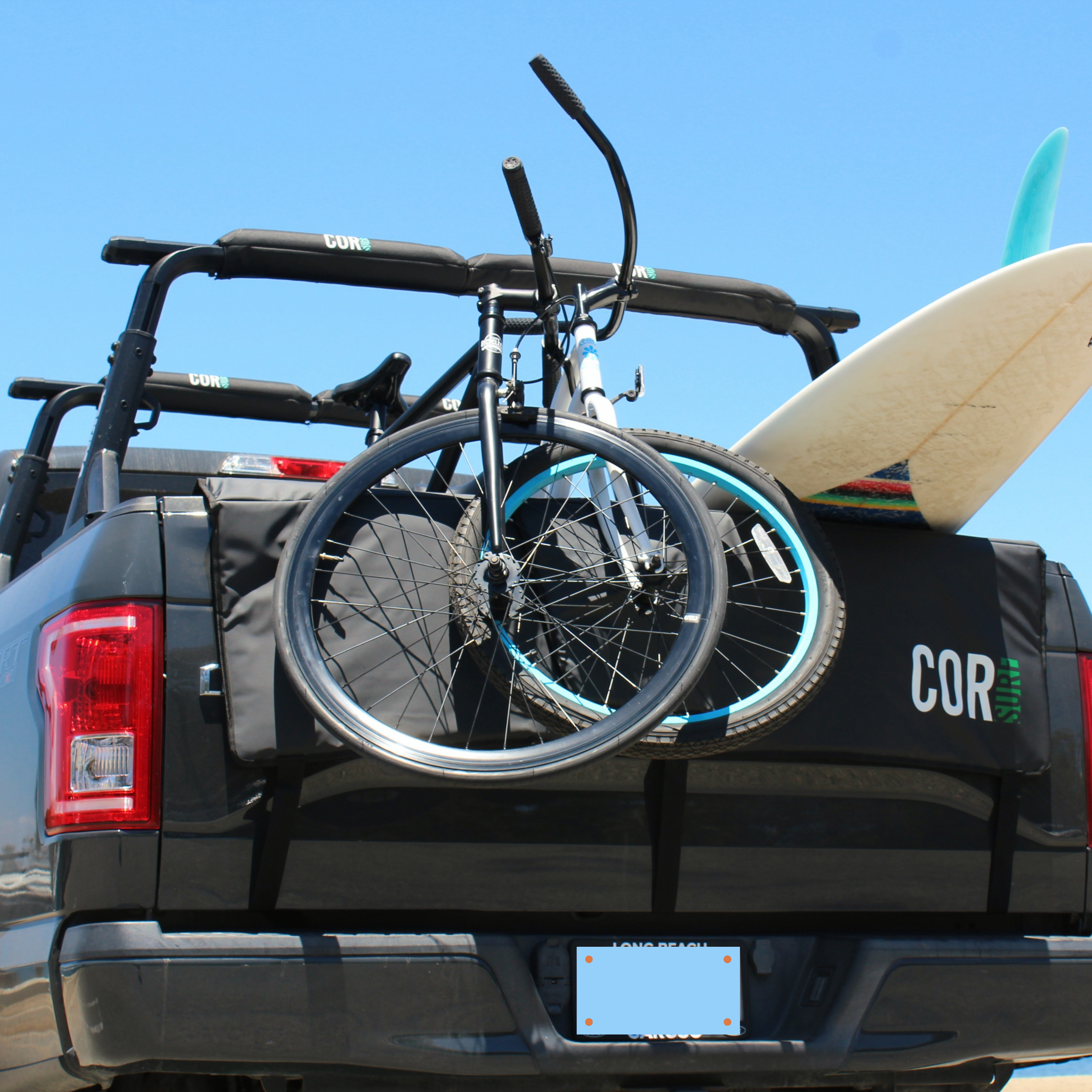 COR Surf tailgate pad for bikes and surfboards, available in two sizes, offers secure transportation and protection for gear.