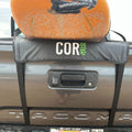 COR Surf tailgate truck pad for surfboards and paddleboards, showing the longboard rack secured on a vehicle tailgate.