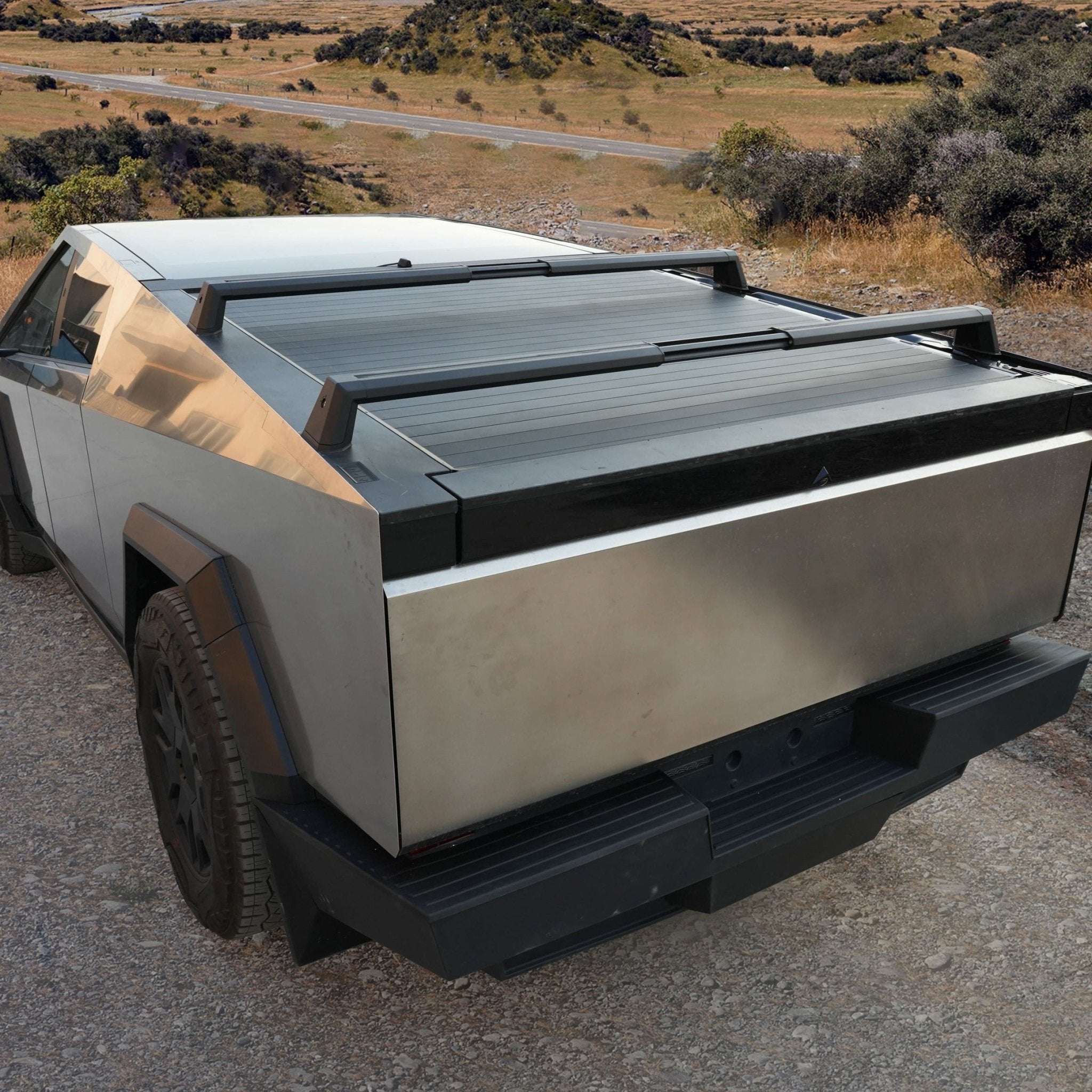 Tesla Cybertruck adjustable crossbar roof rack carrier by CyberGearco mounted on the vehicle's roof for cargo transport.
