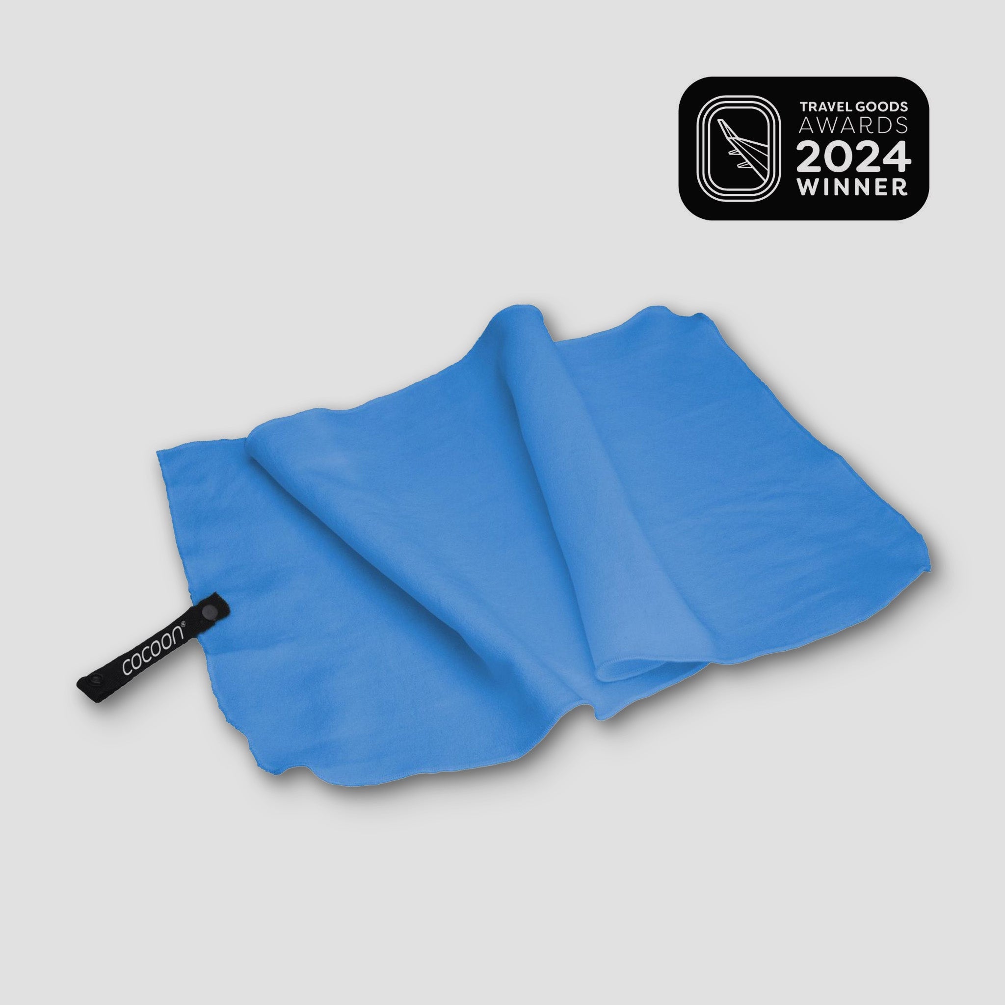 COCOON Hyperlight Travel Towel in vibrant color, showcasing lightweight and compact design for easy portability.