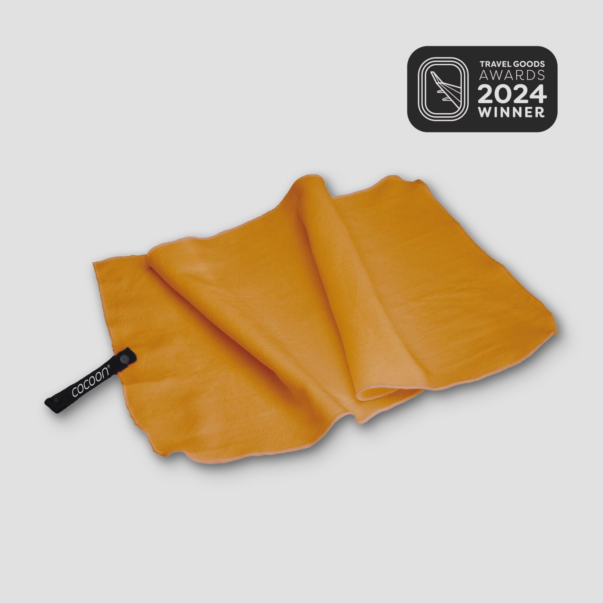 COCOON Hyperlight Travel Towel in vibrant color, showcasing lightweight, compact design for easy portability.