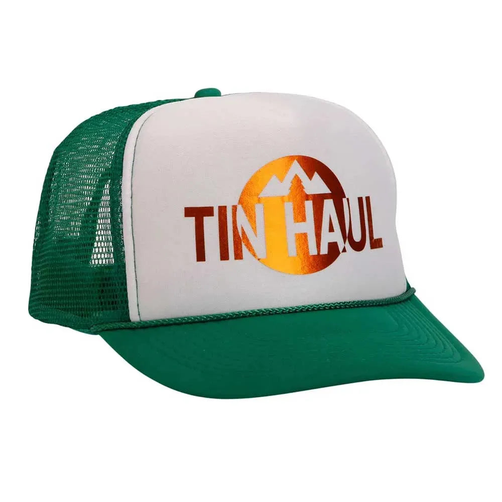 White and green Tin Haul Mountain trucker cap with mesh back, branded by HatCountry, shown from the front on a flat surface.