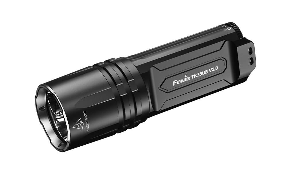 Fenix TK35UE V2.0 tactical flashlight with a powerful 5000 lumens beam, showcasing its durable design and compact size.