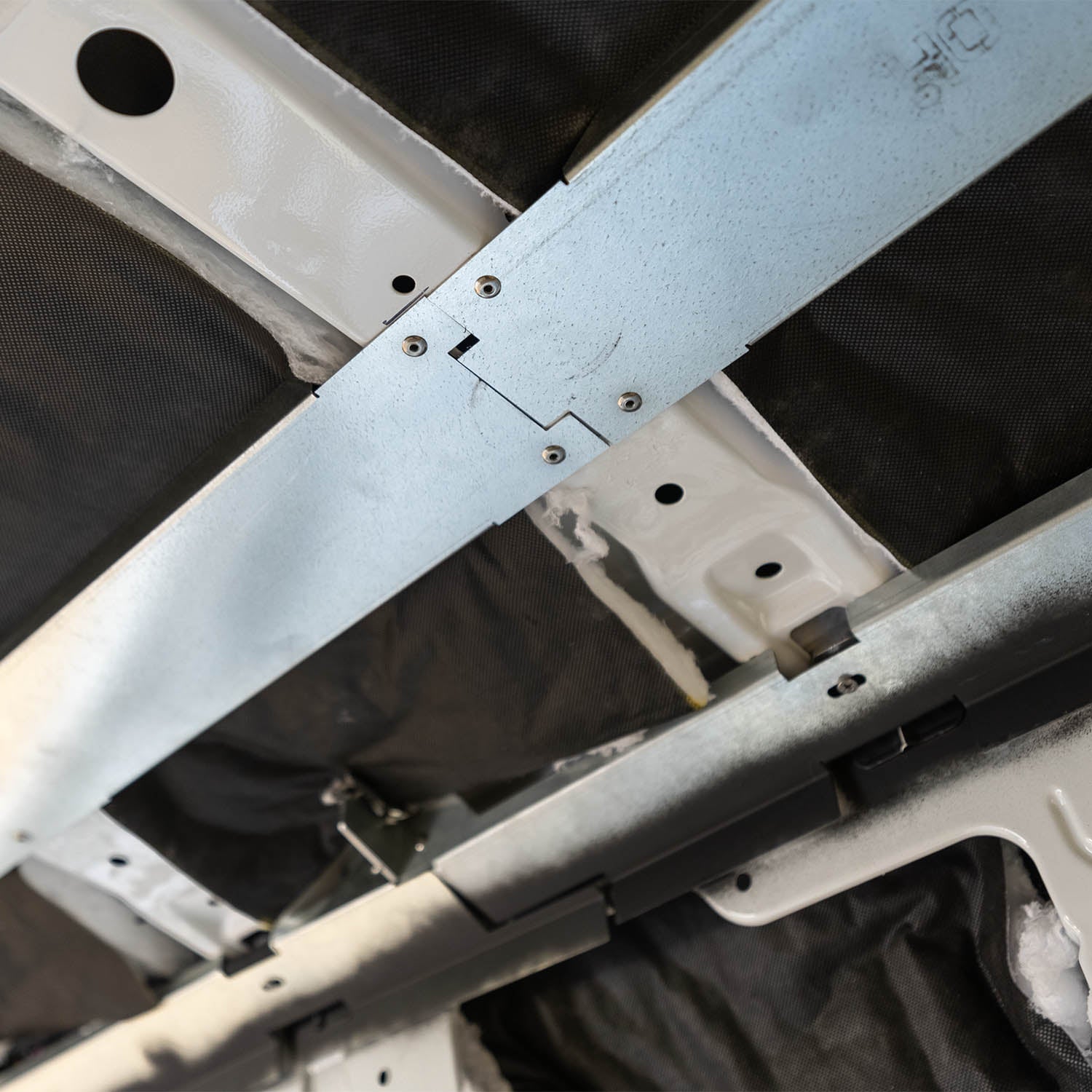 Timber Van Kits overhead cabinet panels for transit vans, showing structural assembly with wood panels and hardware.