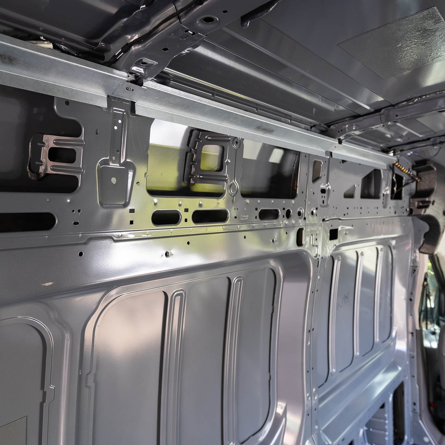 Structural assembly panels for transit van by Timber Van Kits, showing metal framing and panel fitment inside the vehicle.