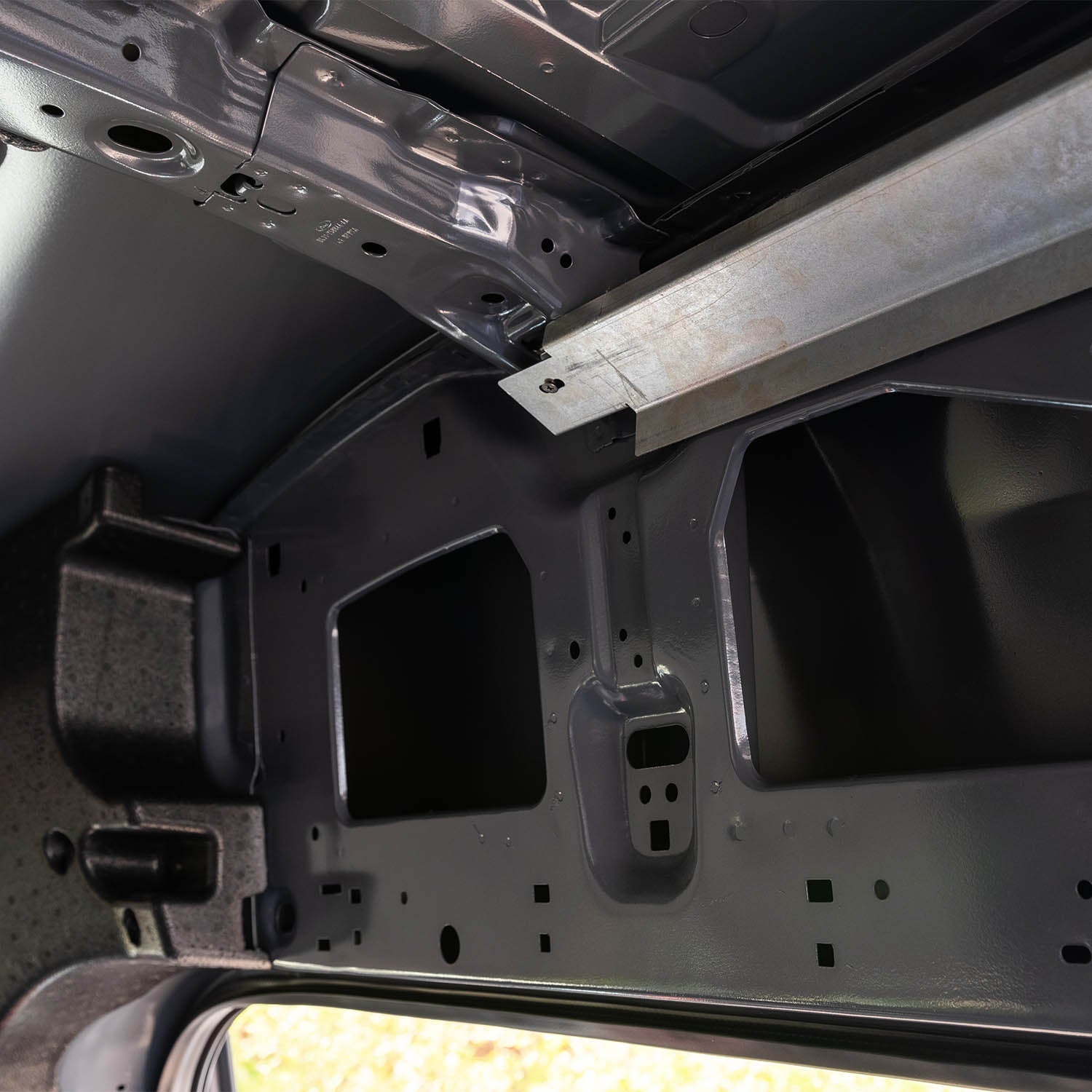 Timber Van Kits transit van panels structural assembly showing metal framework and panel connections in a workshop setting.