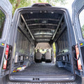 Structural assembly panels for transit van by Timber Van Kits, showing metal framework and panel connections inside the vehicle.