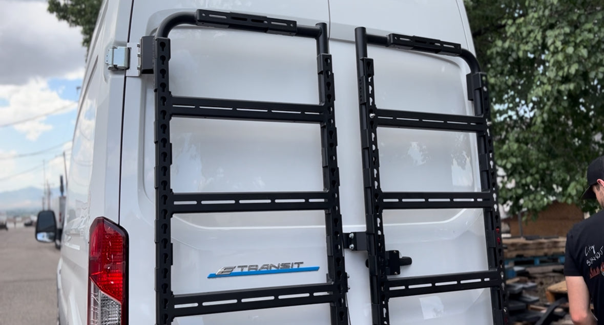 Avatar Offroad Massif Van Rear Door Storage Mounting System installed on a Transit van, showing durable metal construction and secure mounting points.