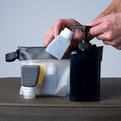 Gravel Honey Glacier 3oz travel bottles two-pack, reusable plastic containers for liquids, with secure screw caps.