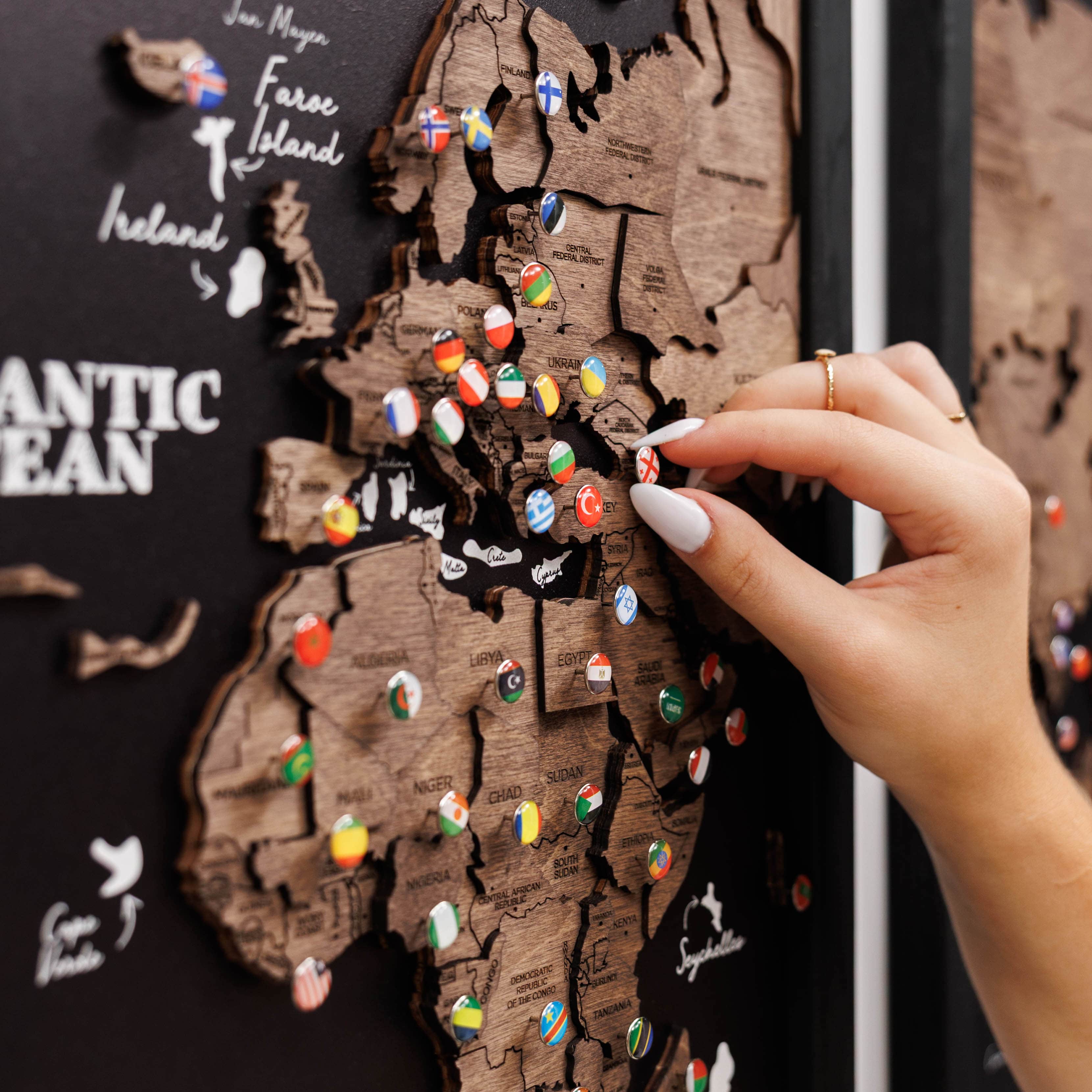 Dark walnut wooden triptych world map by Enjoy The Wood, showcasing a three-panel design with detailed continents and oceans.