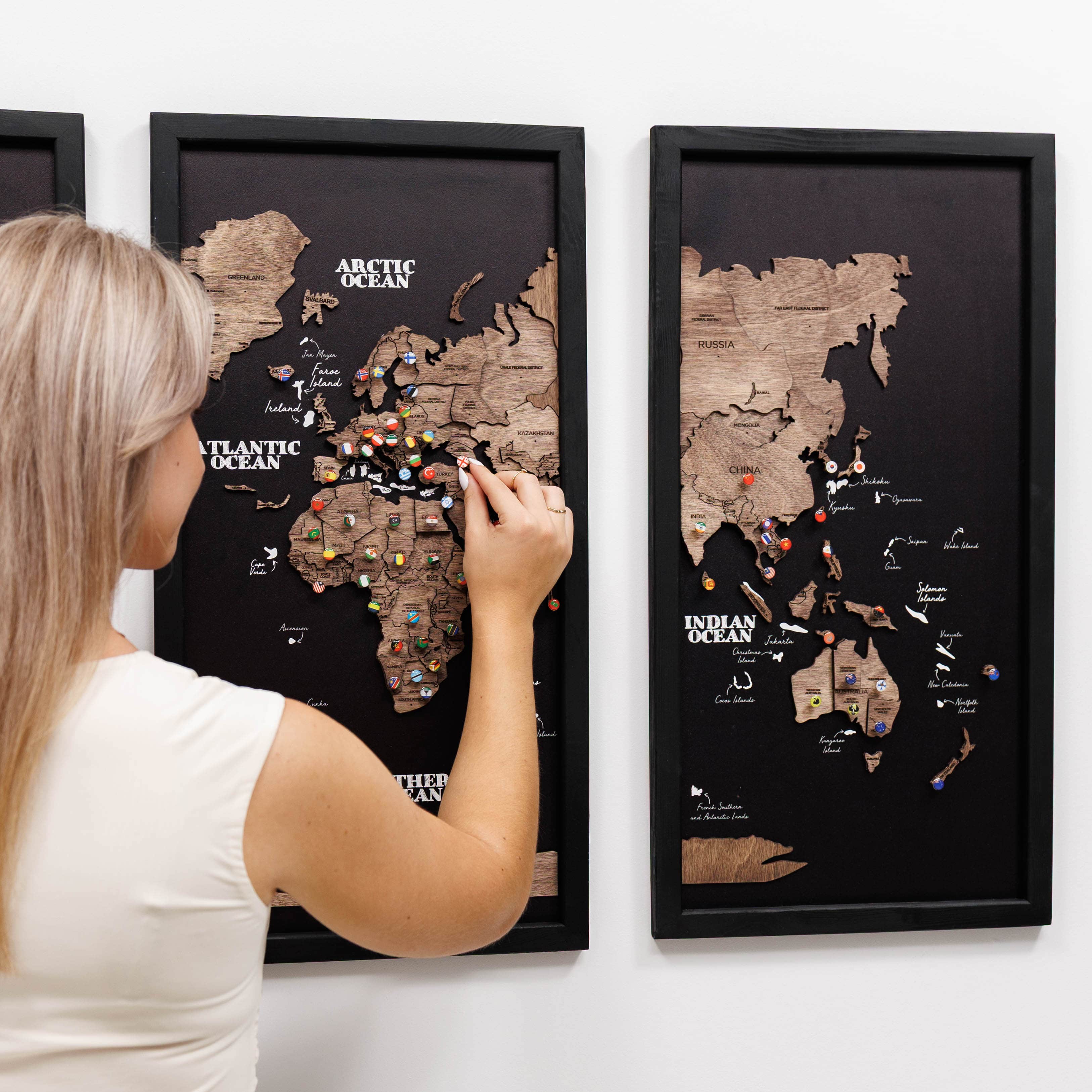 Dark walnut wooden triptych world map by Enjoy The Wood, featuring detailed carved landmasses on three panels.
