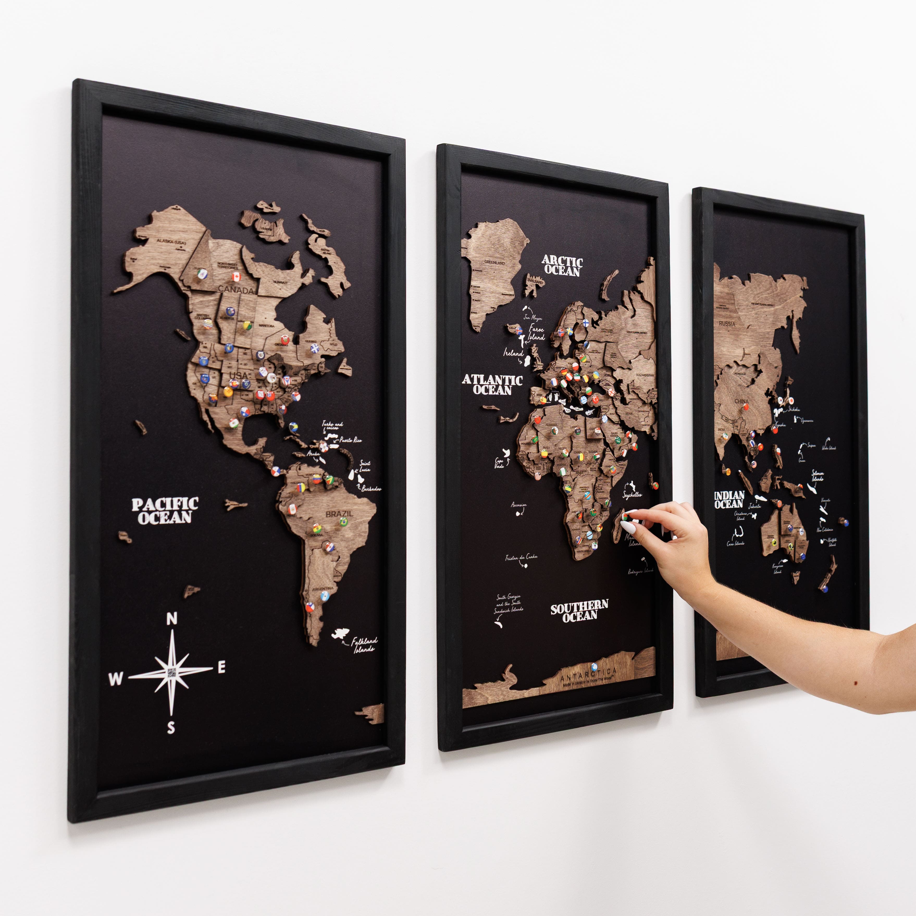 Dark walnut wooden triptych world map by Enjoy The Wood, featuring three panels with detailed carved continents and oceans.