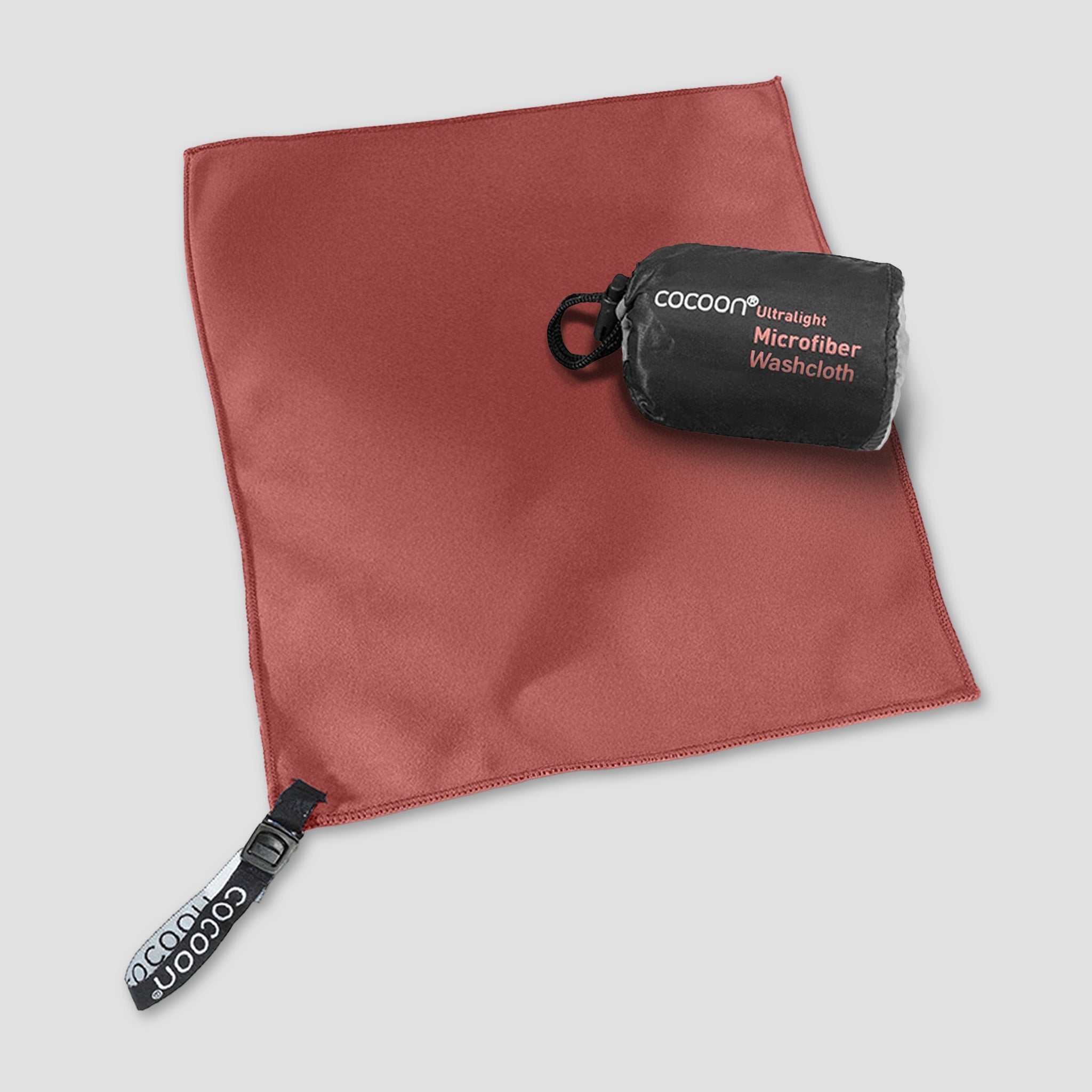 COCOON ultralight microfiber towel spread out on a surface, showcasing its soft, compact, quick-drying fabric ideal for travel and outdoor use.