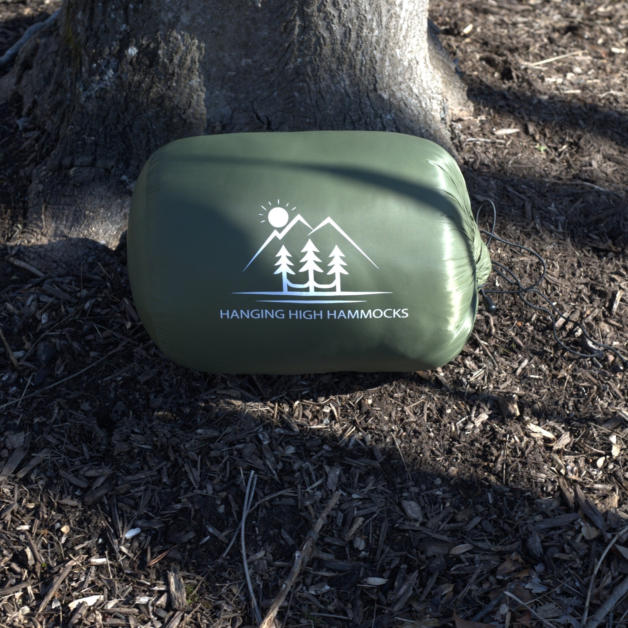 Hanging High Hammocks EmberNest Underquilt 30°F rated attached to a hammock, ideal for outdoor camping and cold weather adventures.