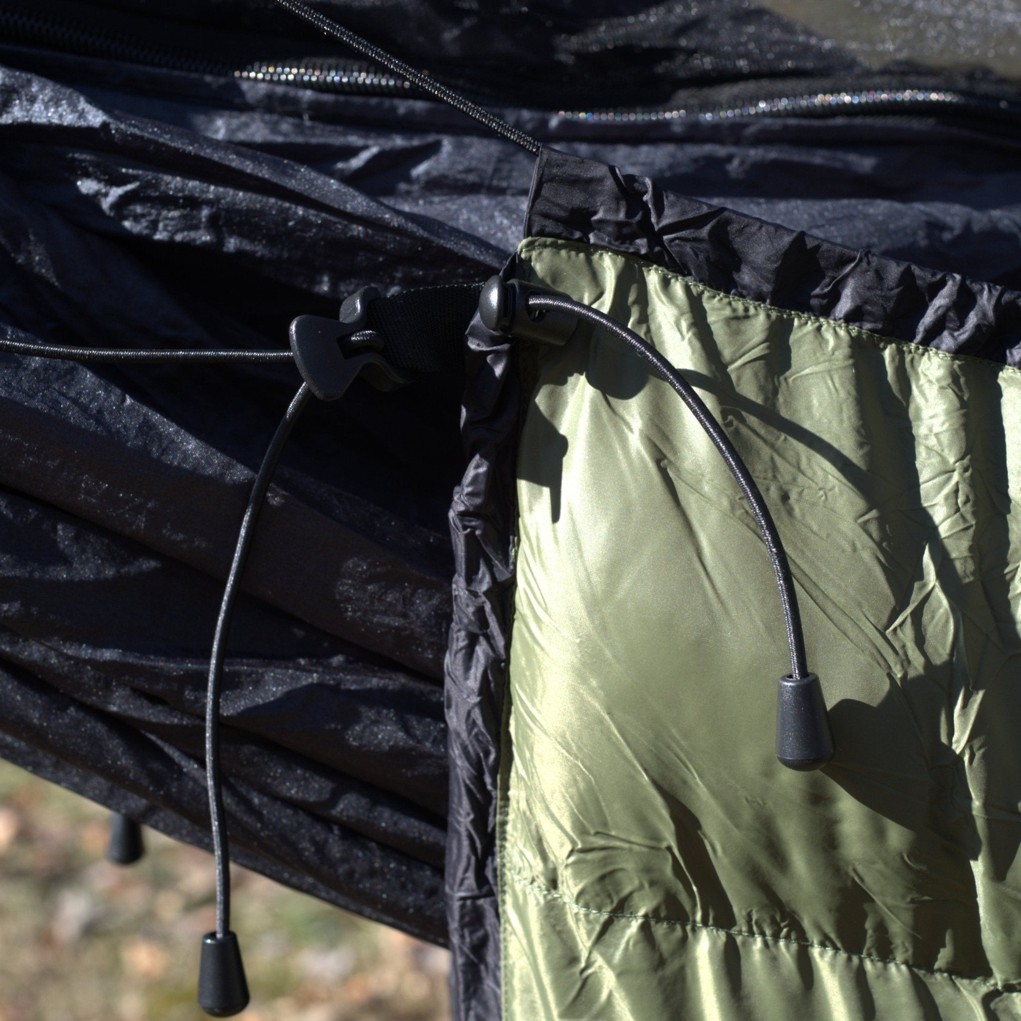Hanging High Hammocks EmberNest Underquilt 30°F rated, shown attached to a hammock for cold weather camping comfort.