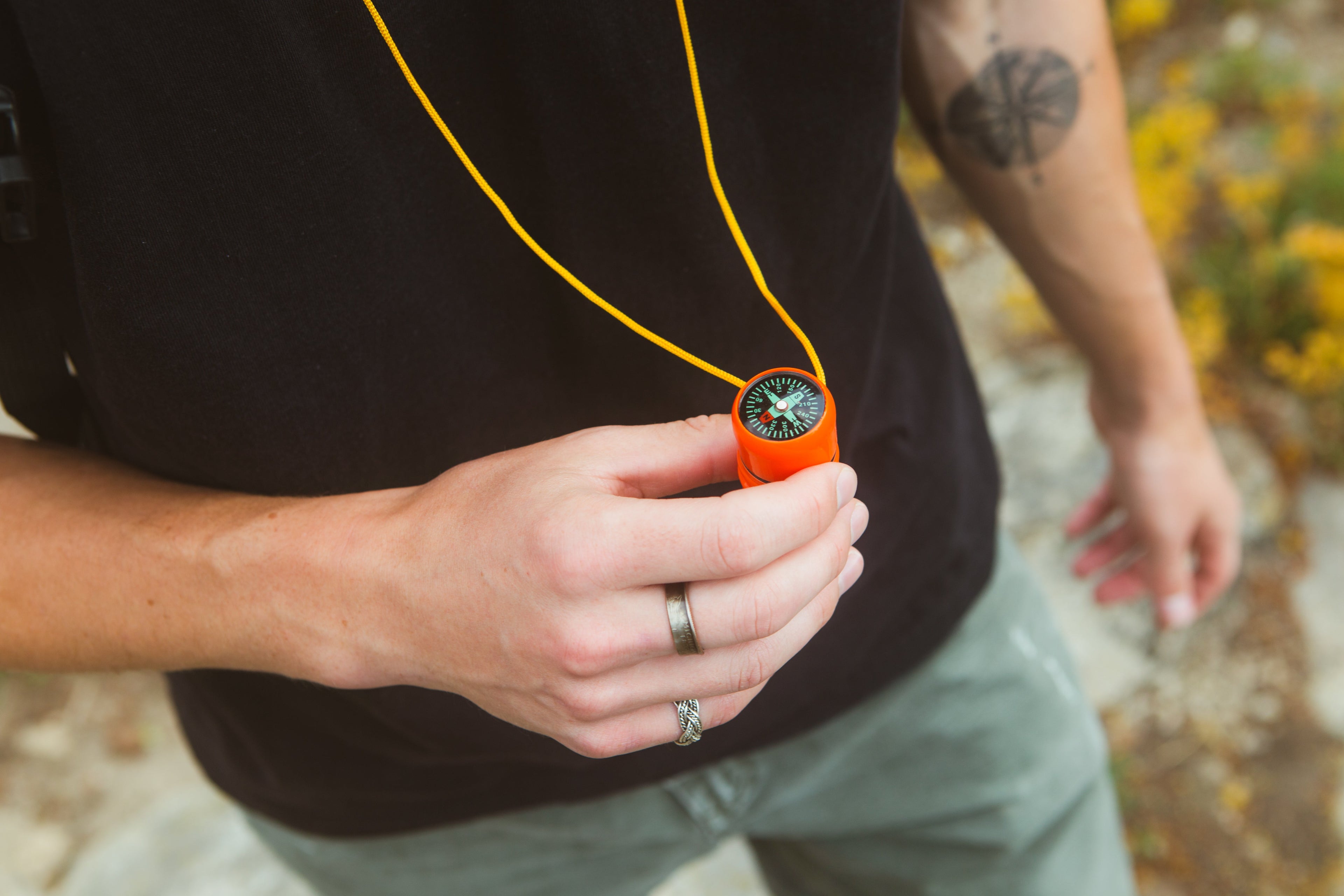 Ultra-loud 5-in-1 survival whistle with signaling mirror, compact emergency tool for outdoor safety and survival situations.