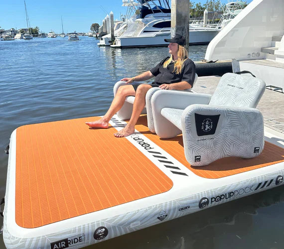 Backcountry Sportsman inflatable dock and swim platform floating on water with a blue sky background
