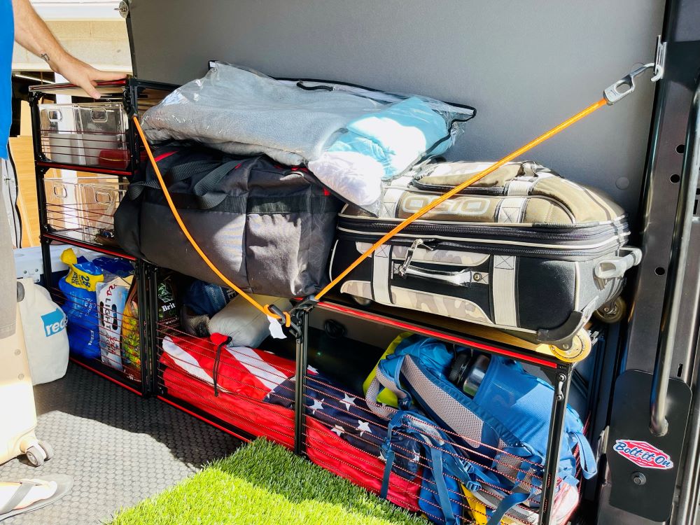 Ford Transit camper van with TNTvans wheel well bench storage loaded with gear, ideal for DIY van conversion projects.