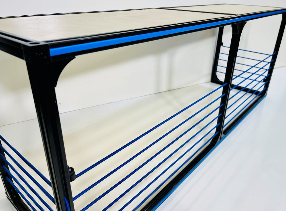 Camper van wheel well storage area with built-in bench seat in a TNTvans DIY conversion kit interior.