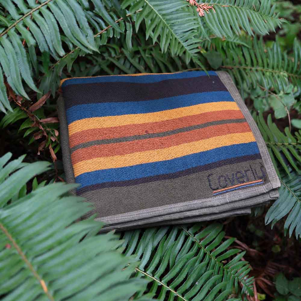 West Path waxed canvas camping blanket spread open, showing its durable outdoor throw blanket design for camping and bushcraft activities.
