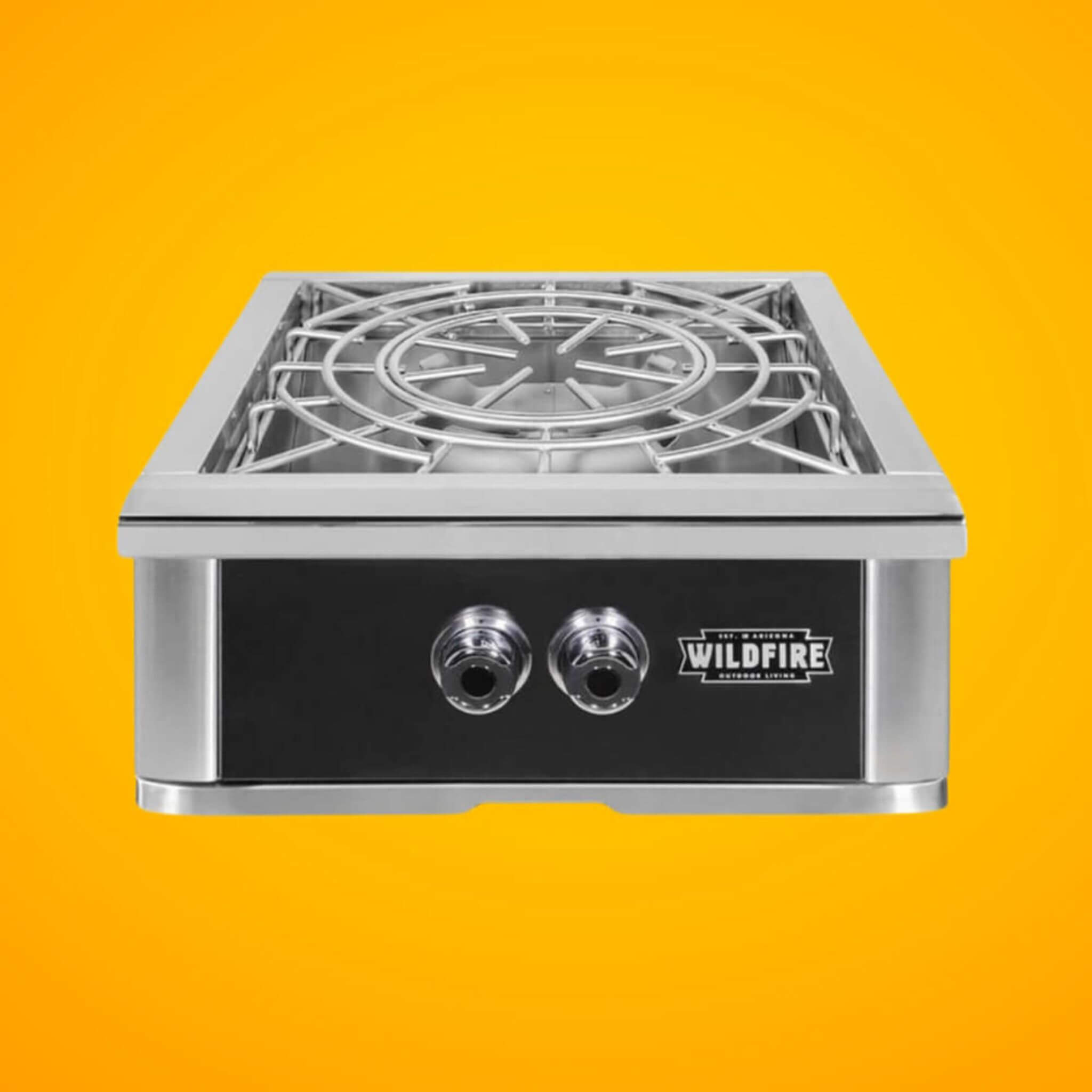 Wildfire Ranch Pro 24-Inch Stainless Steel Power Burner with front view on an orange background.
