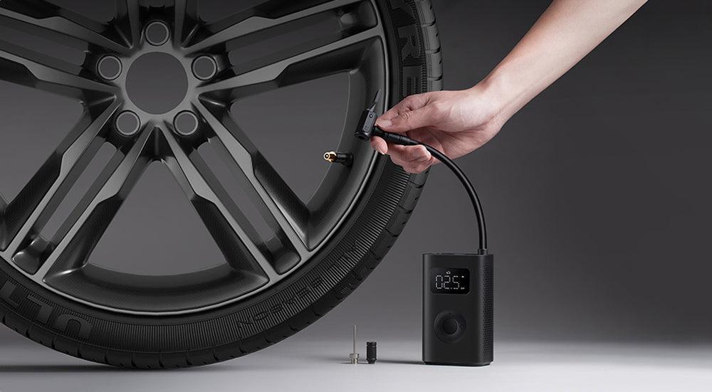 Xiaomi Mijia Portable Electric Air Inflator 2, compact electric pump with digital display and air hose for inflating tires and sports equipment.