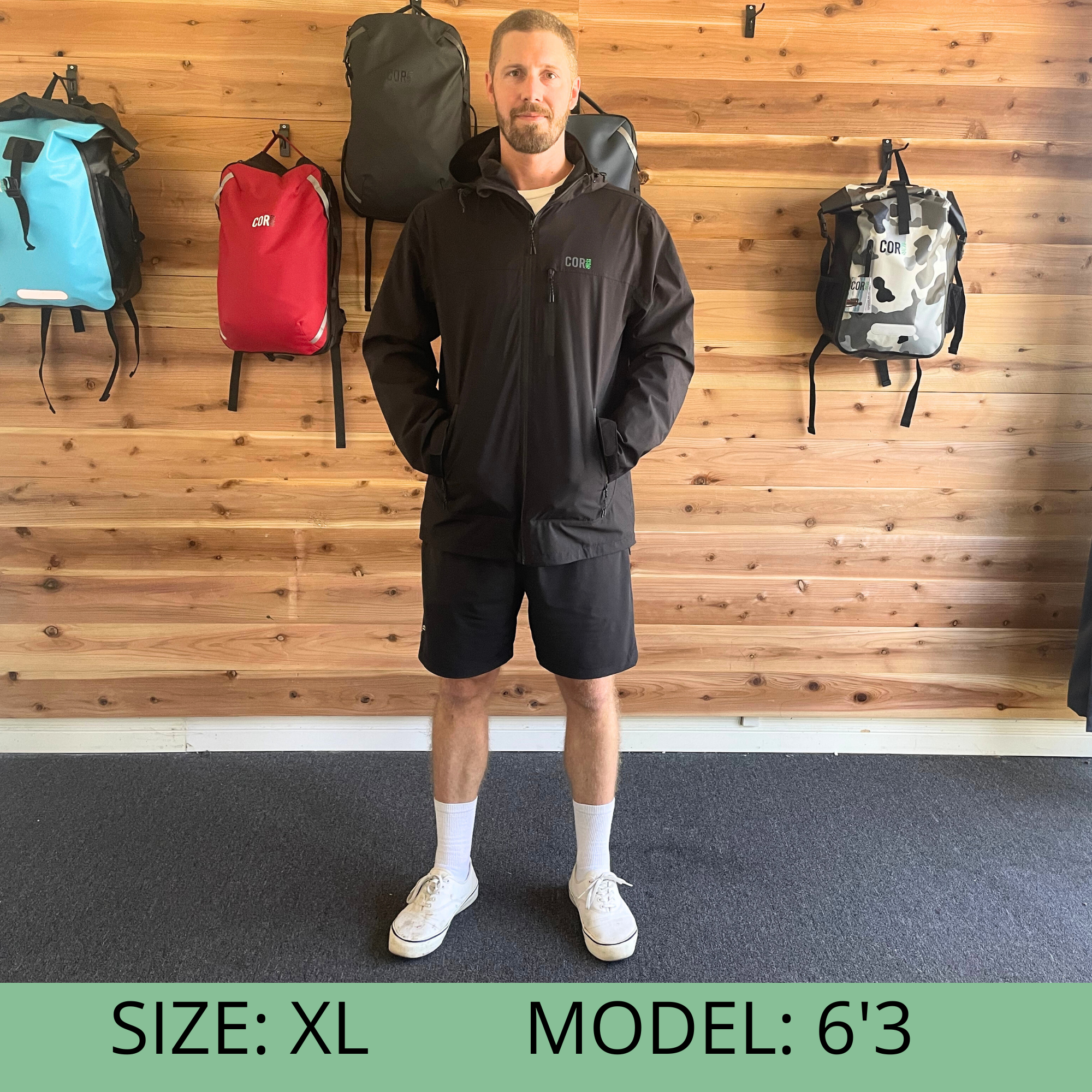 Unisex COR Surf Huakai Travel Rain Jacket in XL, lightweight waterproof outdoor apparel with hood and adjustable cuffs.