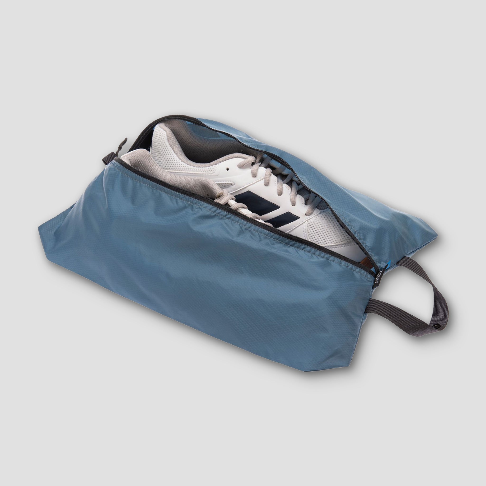 Pair of COCOON Shoe Bags for organizing and protecting shoes, shown in a sleek, compact design.