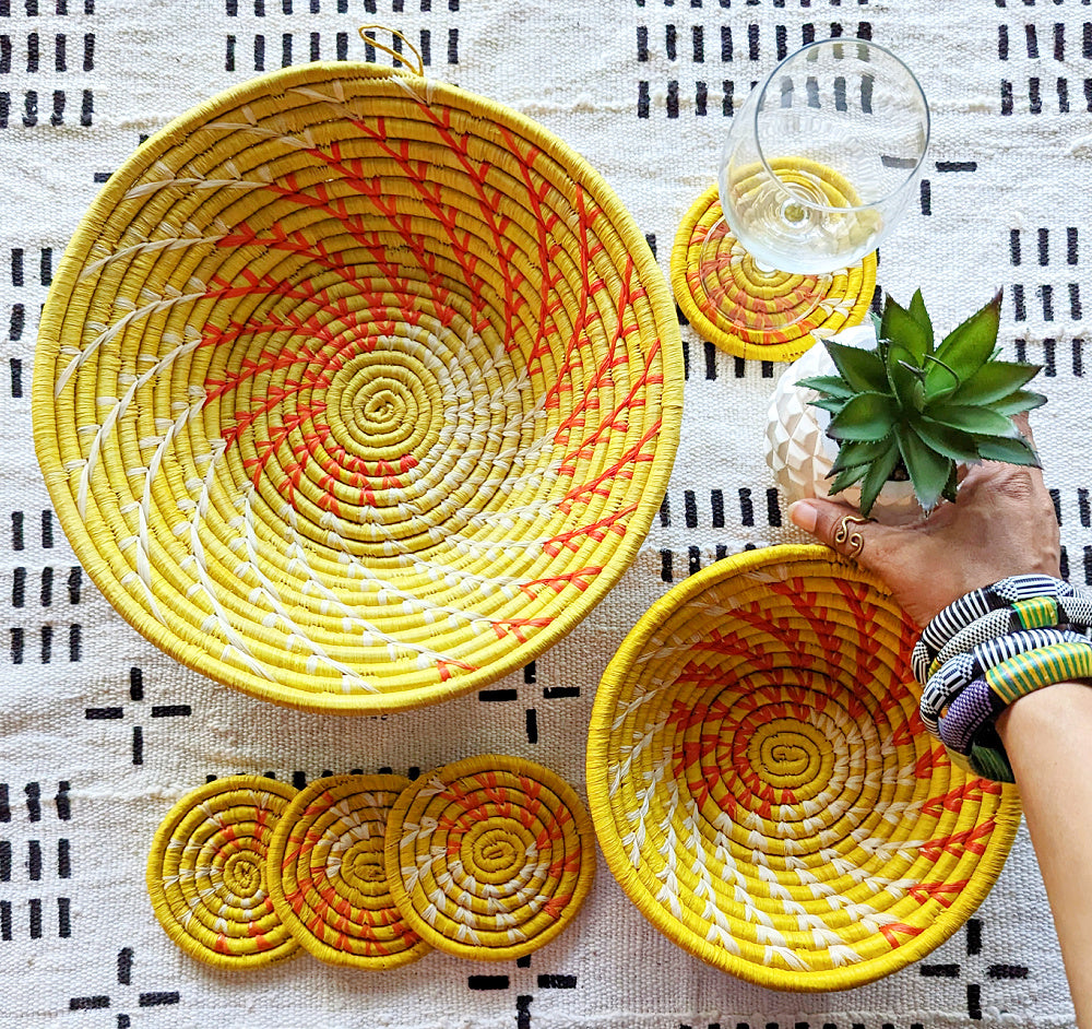 Large yellow woven African basket by Reflektion Design, showcasing intricate woven patterns and vibrant yellow color.
