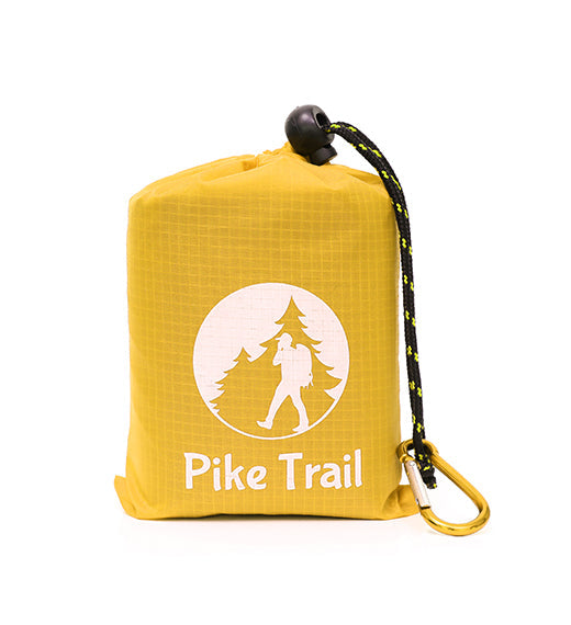 Yellow Pike Trail Pocket Blanket spread out on grass, compact and lightweight for outdoor picnics and adventures.