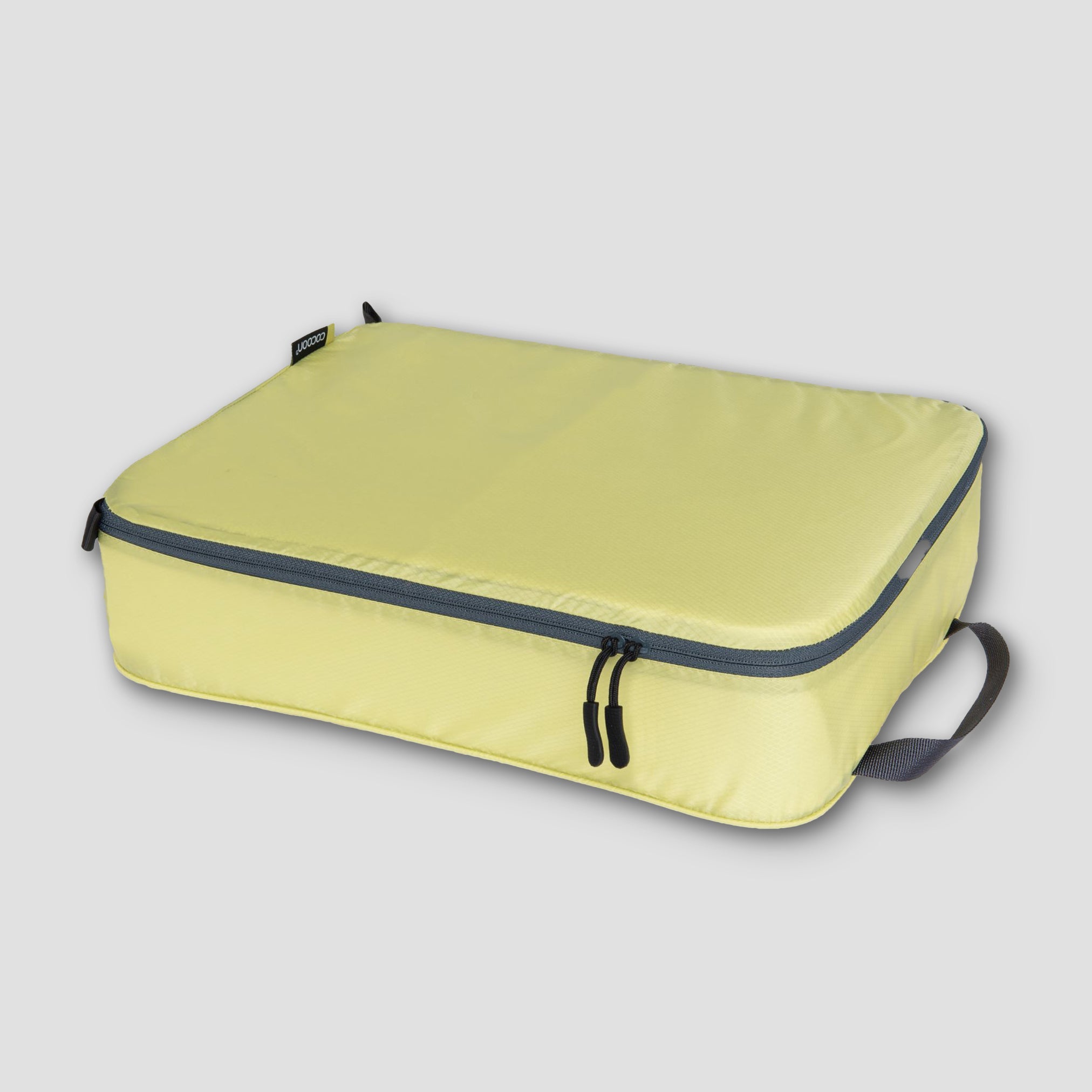 COCOON Discrete Light Packing Cubes for travel organizers, showing compact, lightweight storage bags in different sizes for efficient packing.
