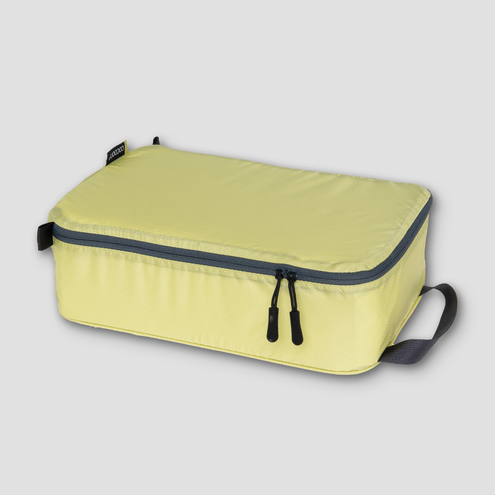 COCOON Discrete Light Packing Cubes for travel organizers, compact and lightweight storage for clothing and accessories.