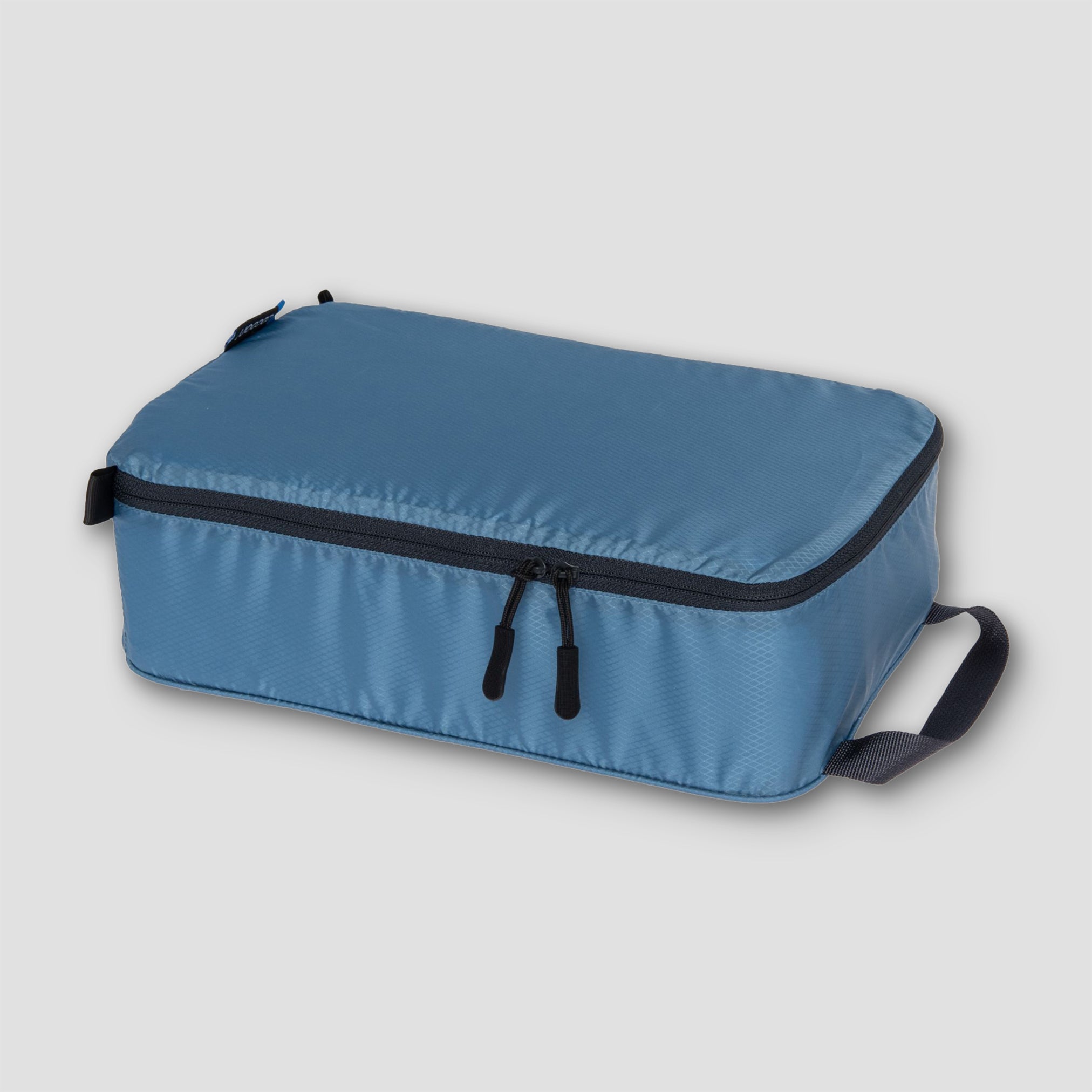 COCOON Discrete Light Packing Cubes travel organizers in various sizes for efficient packing and organization.