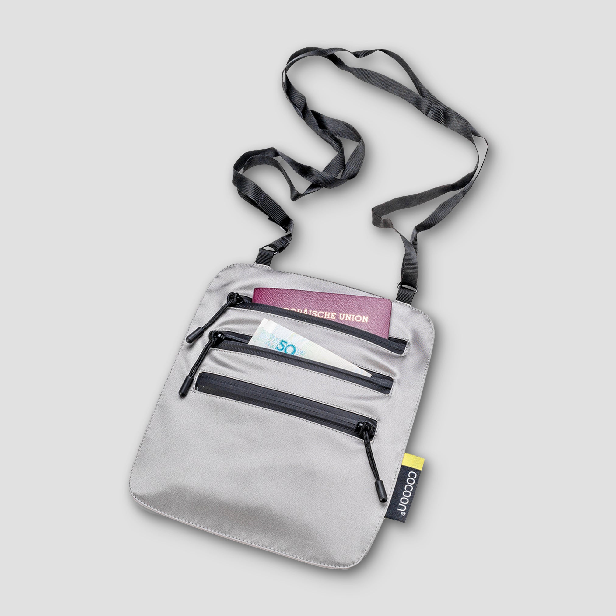 Cocoon Secret Neck Wallet Monsoon Silk RFID with secure compartments and sleek design, worn around the neck for travel safety.