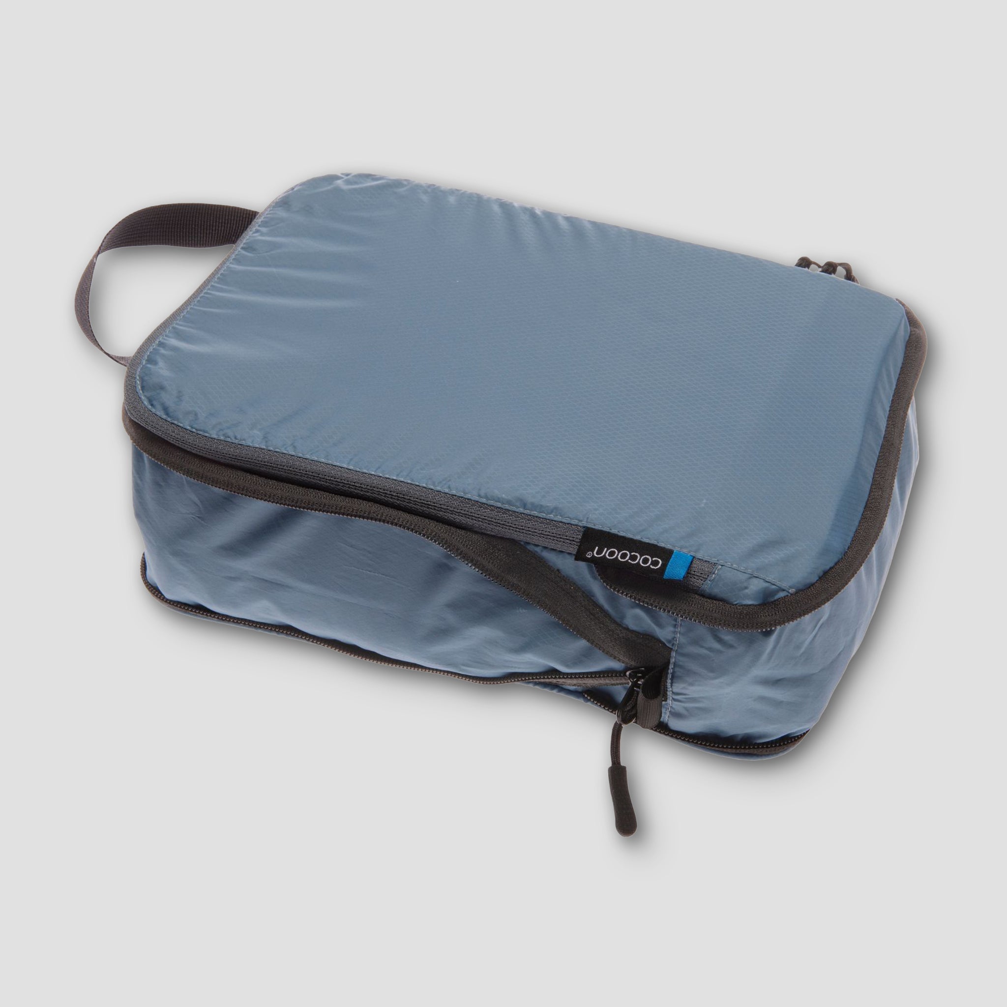 COCOON Squeezer Light Compression Packing Cube, compact and durable, with a zipper closure for efficient packing and space-saving storage.