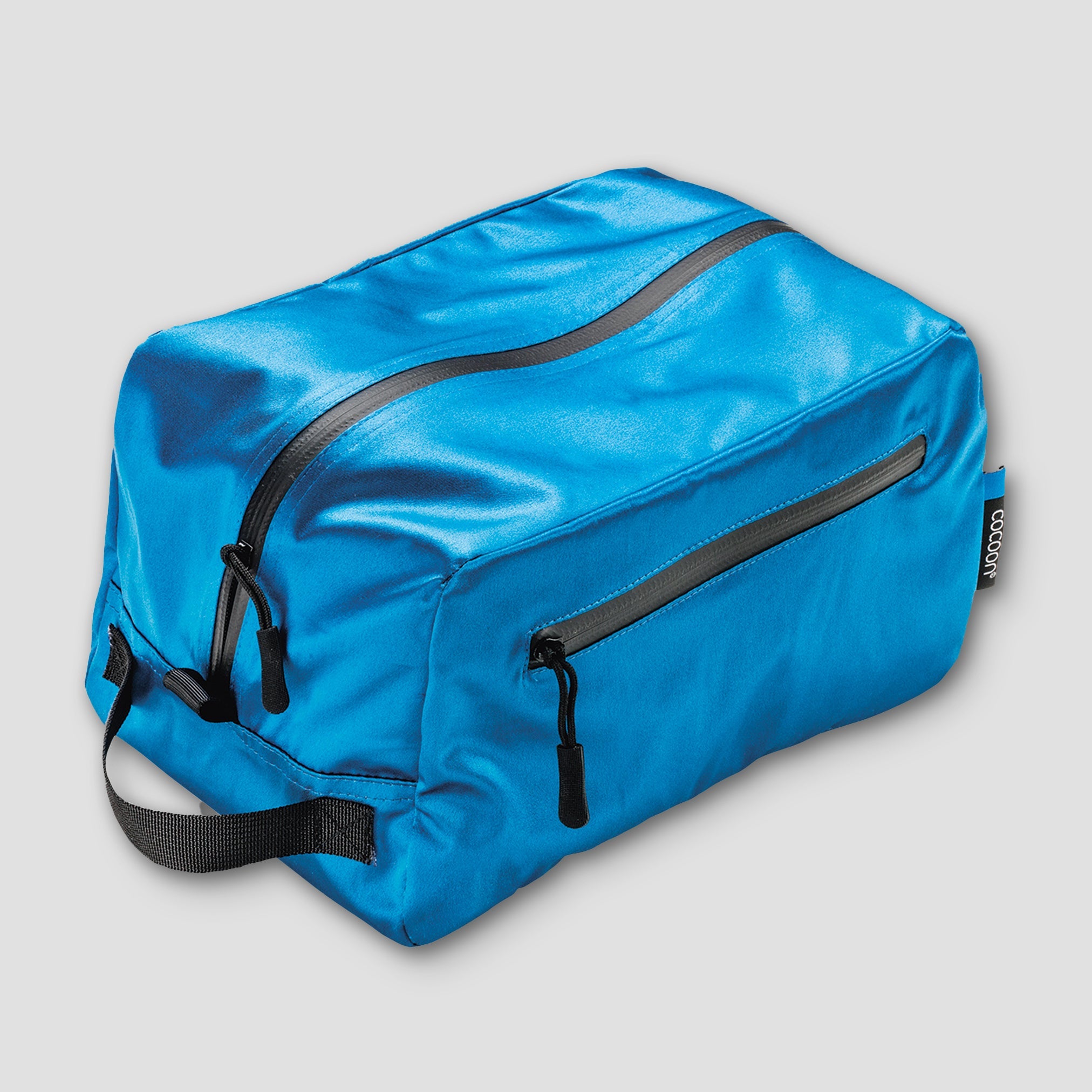 Cocoon Monsoon Silk toiletry kit cube with zipper closure, compact travel organizer for toiletries and grooming essentials.